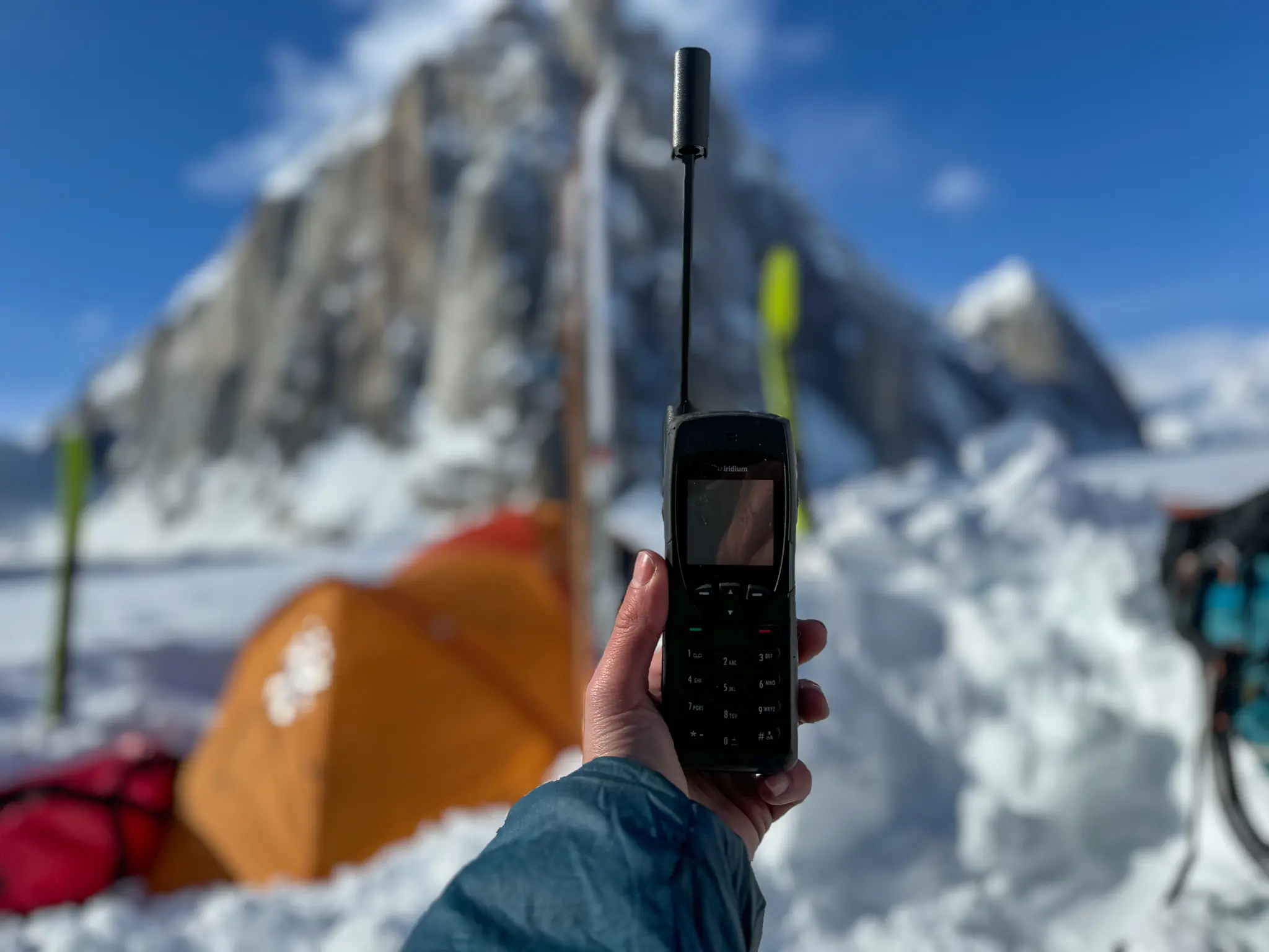 a tester holds a satellite phone infront of themselves