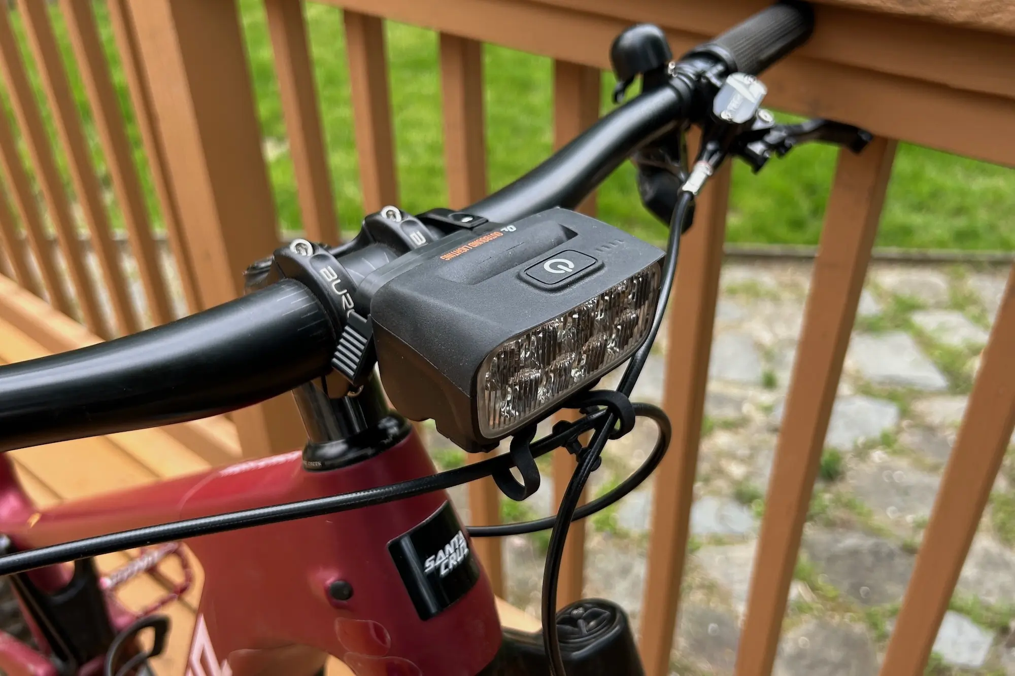 The Outbound Lighting Trail Evo light mounted to a mountain bike handlebar