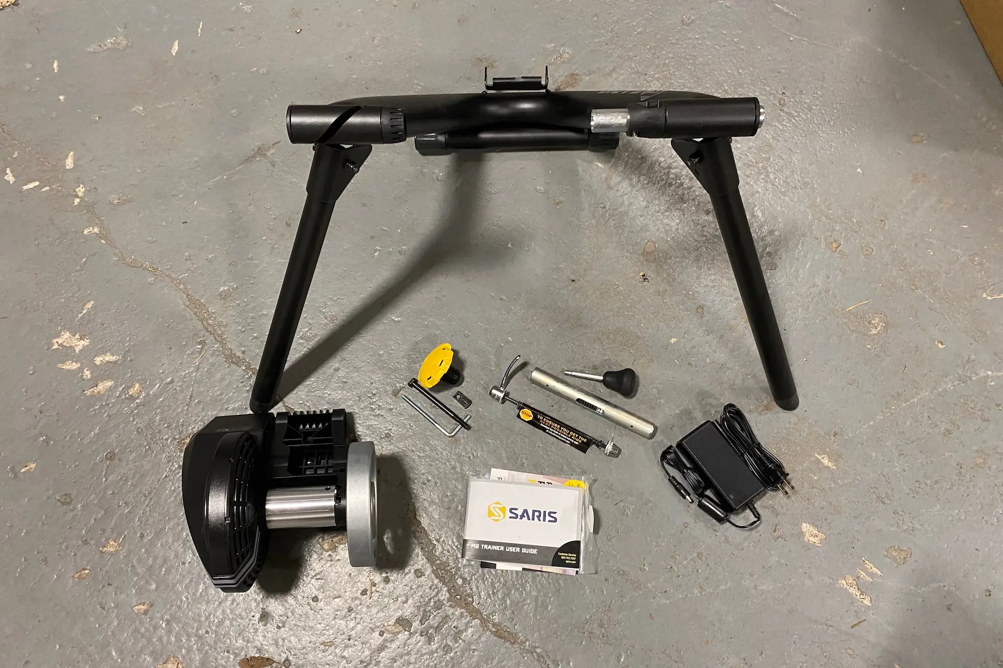 The Saris M2 Smart Trainer and all of it parts before assembly and setup.