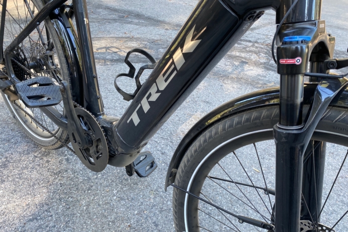 The battery compartment and suspension fork of the Trek Allant+ 7S Gen 2 electric commuter bike