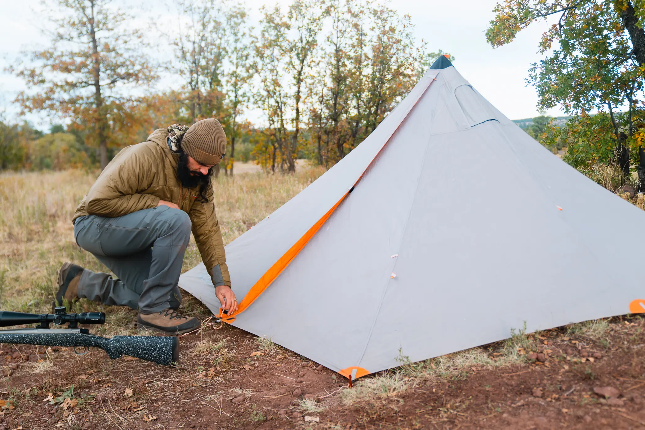 man next to the tent