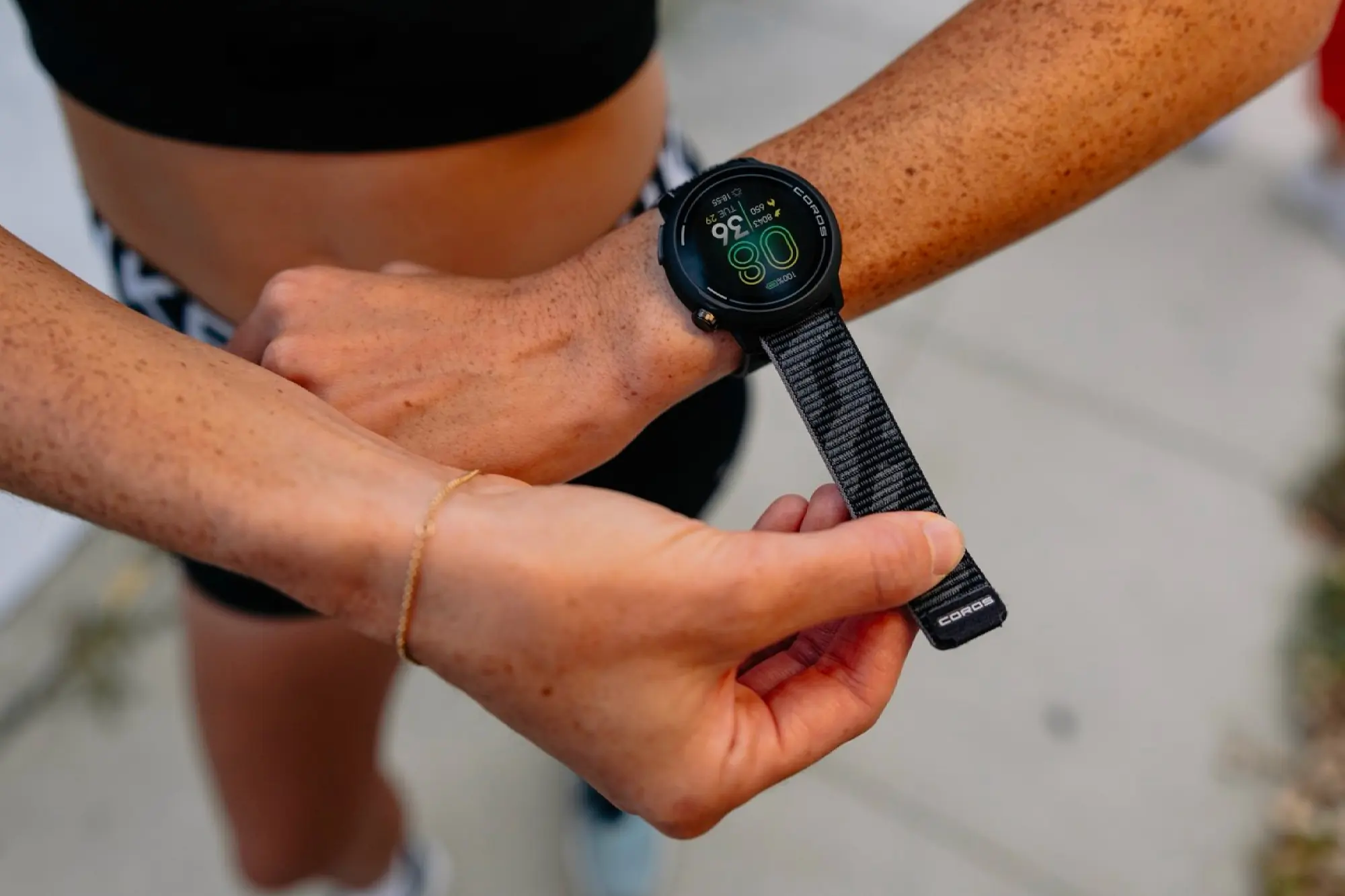 woman strapping coros pace pro watch