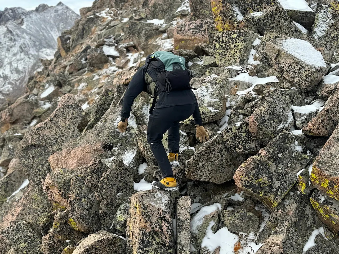 man hiking in the nort face summit series offtrail tr shoes on rocky terrain