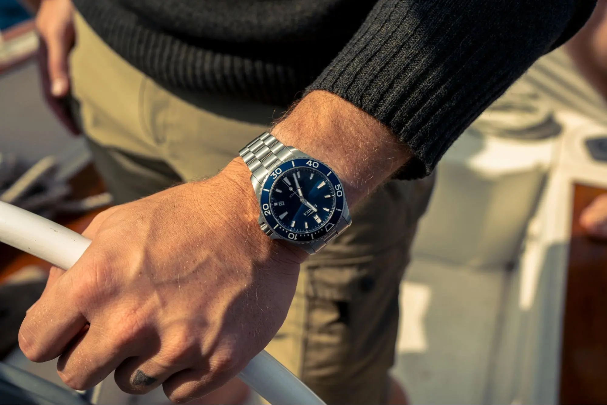 A close-up of a Lake Michigan Monster dive watch on a man's wrist