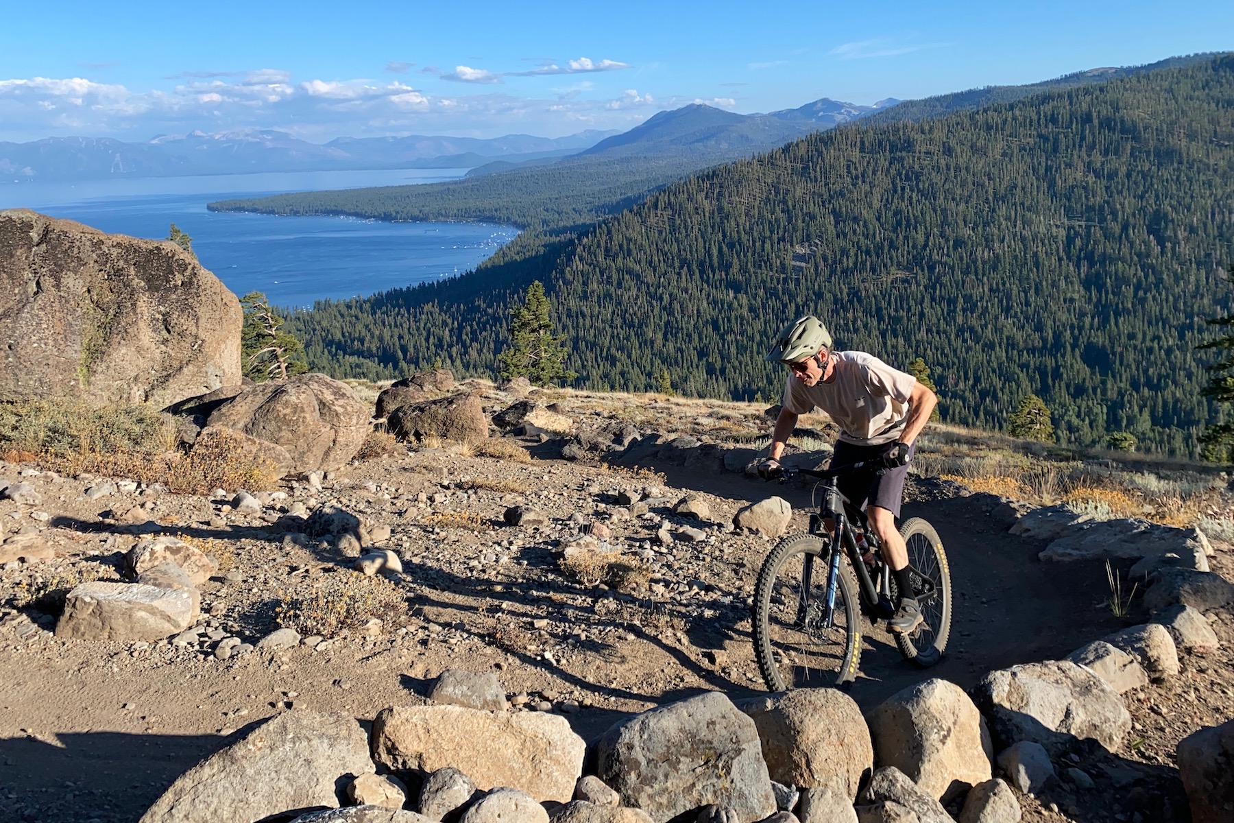 Riding up a mountain bike trail while testing the best mountain bike grips