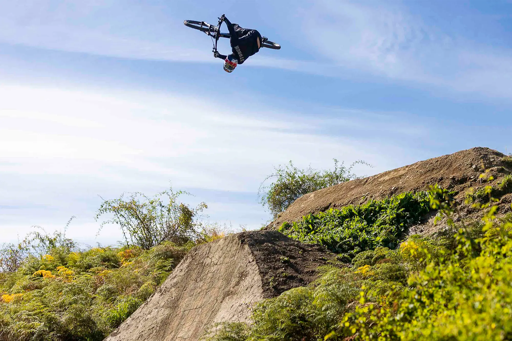 low-angle shot of a rider catching air on their bike