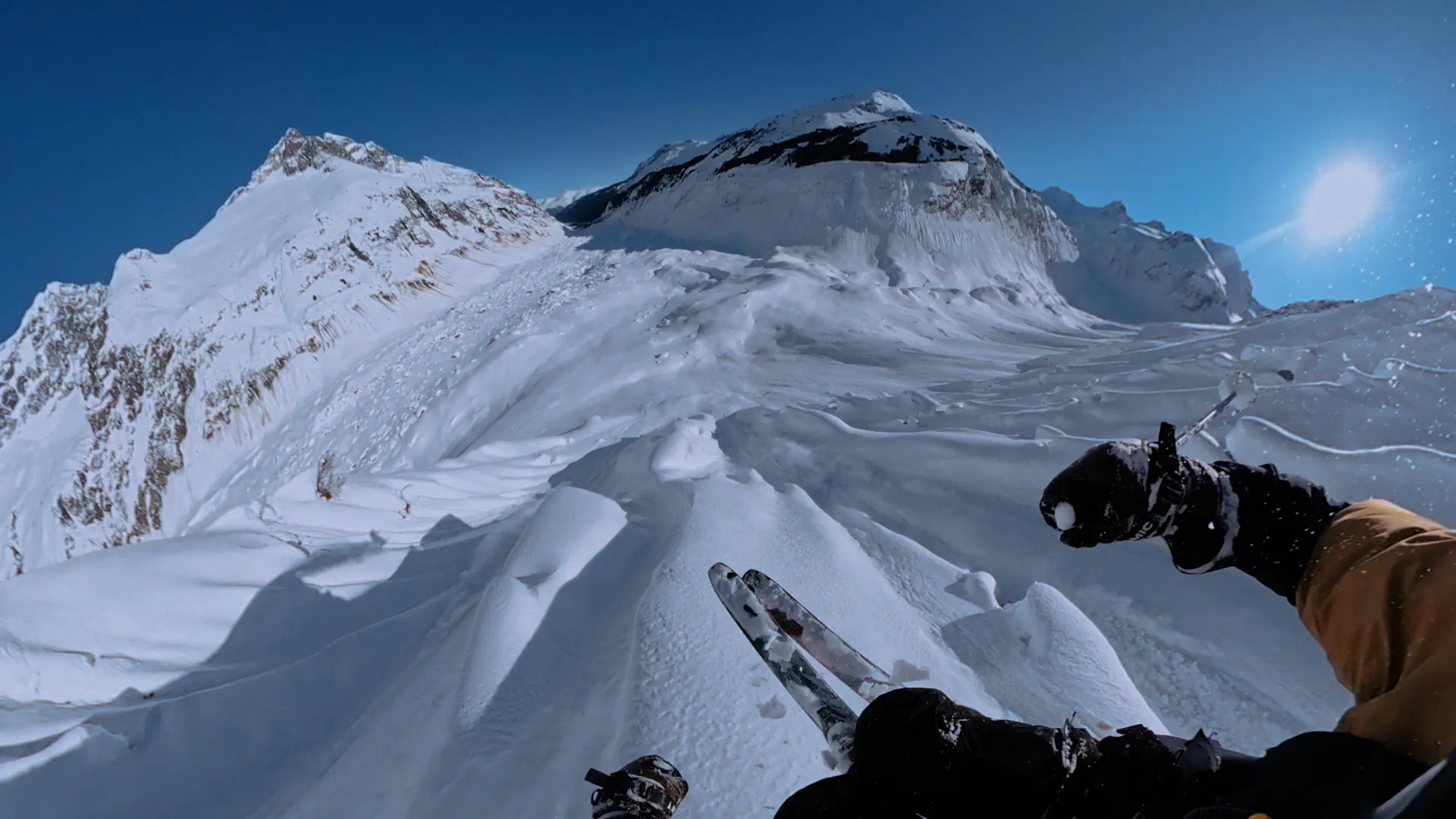 a shot capturing a skier’s point of view with skis in the foreground pointing downhill