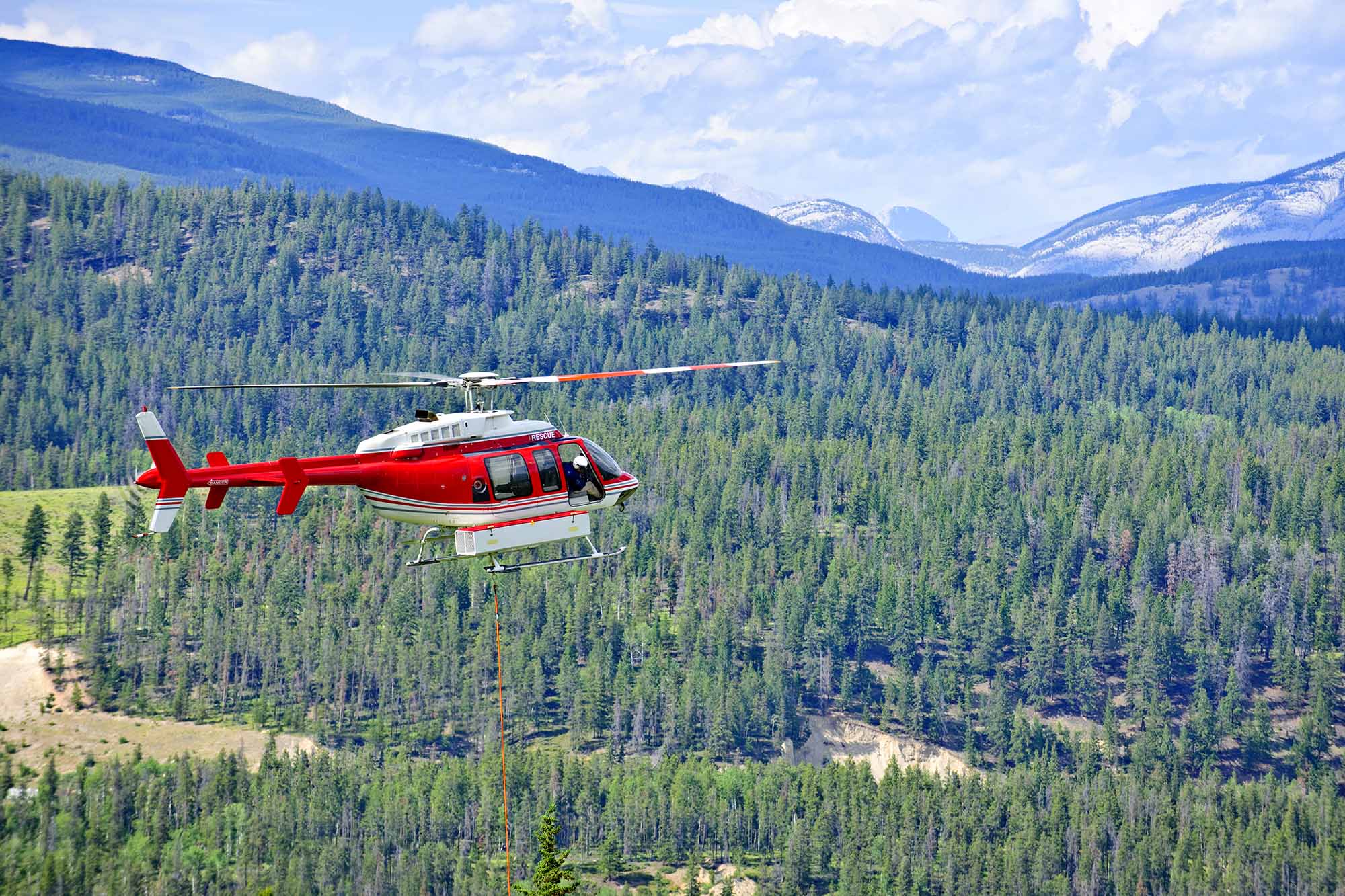 Red,Rescue,Helicopter,Flying,Emergency,Mission,In,Mountains,,Alberta,Canada