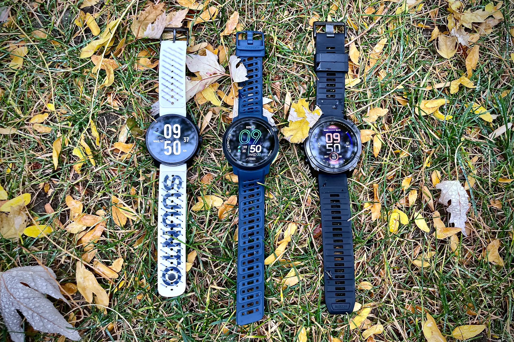suunto race s, pace pro, garmin fenix 8 next to each other on the grass