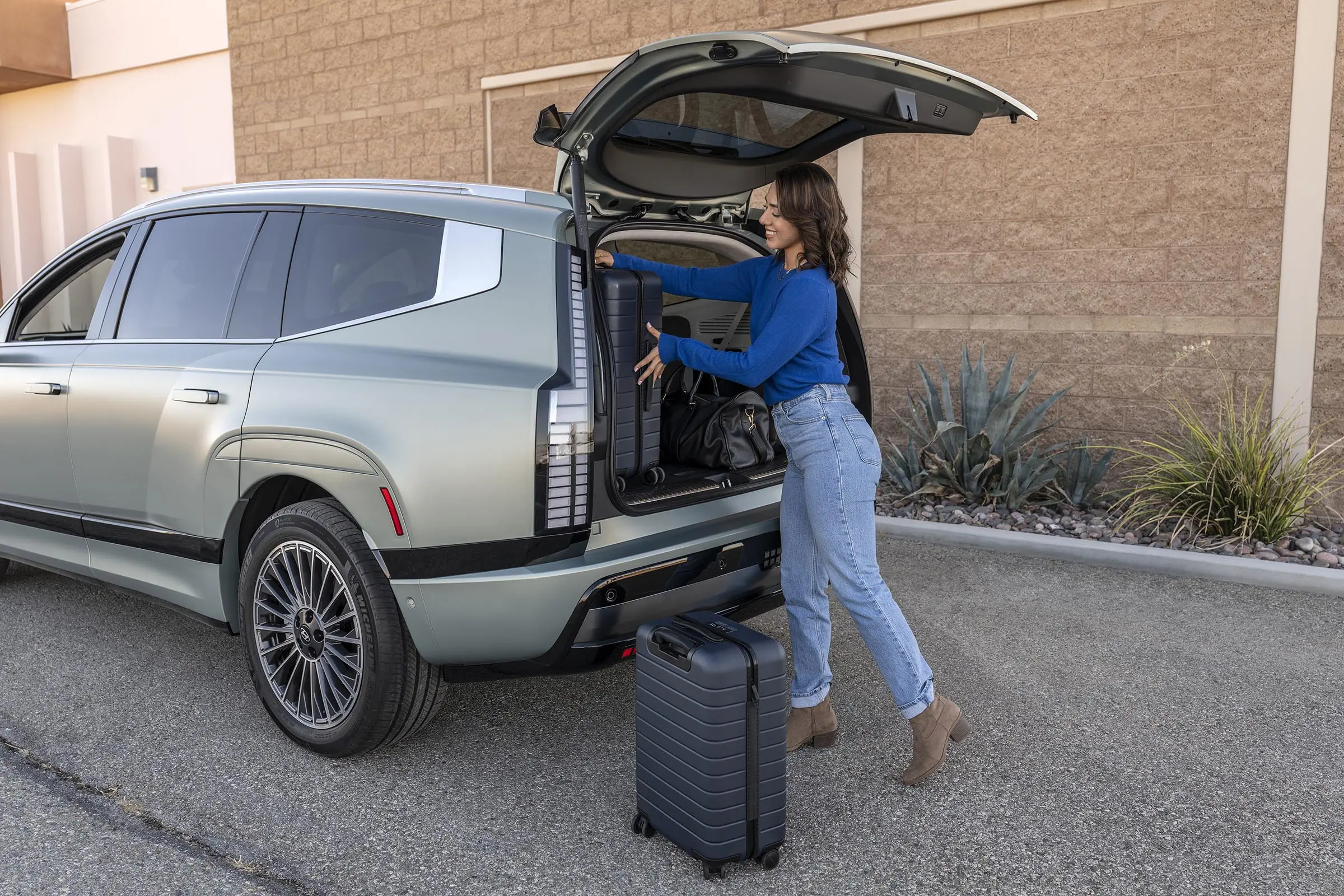 Woman loading back of Hyundai Ioniq 9