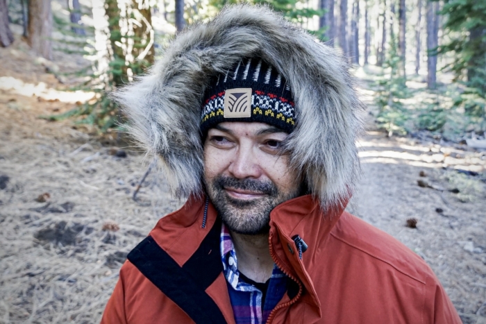 A man models the oversized hood of the Fjallraven Nuuk Parka.