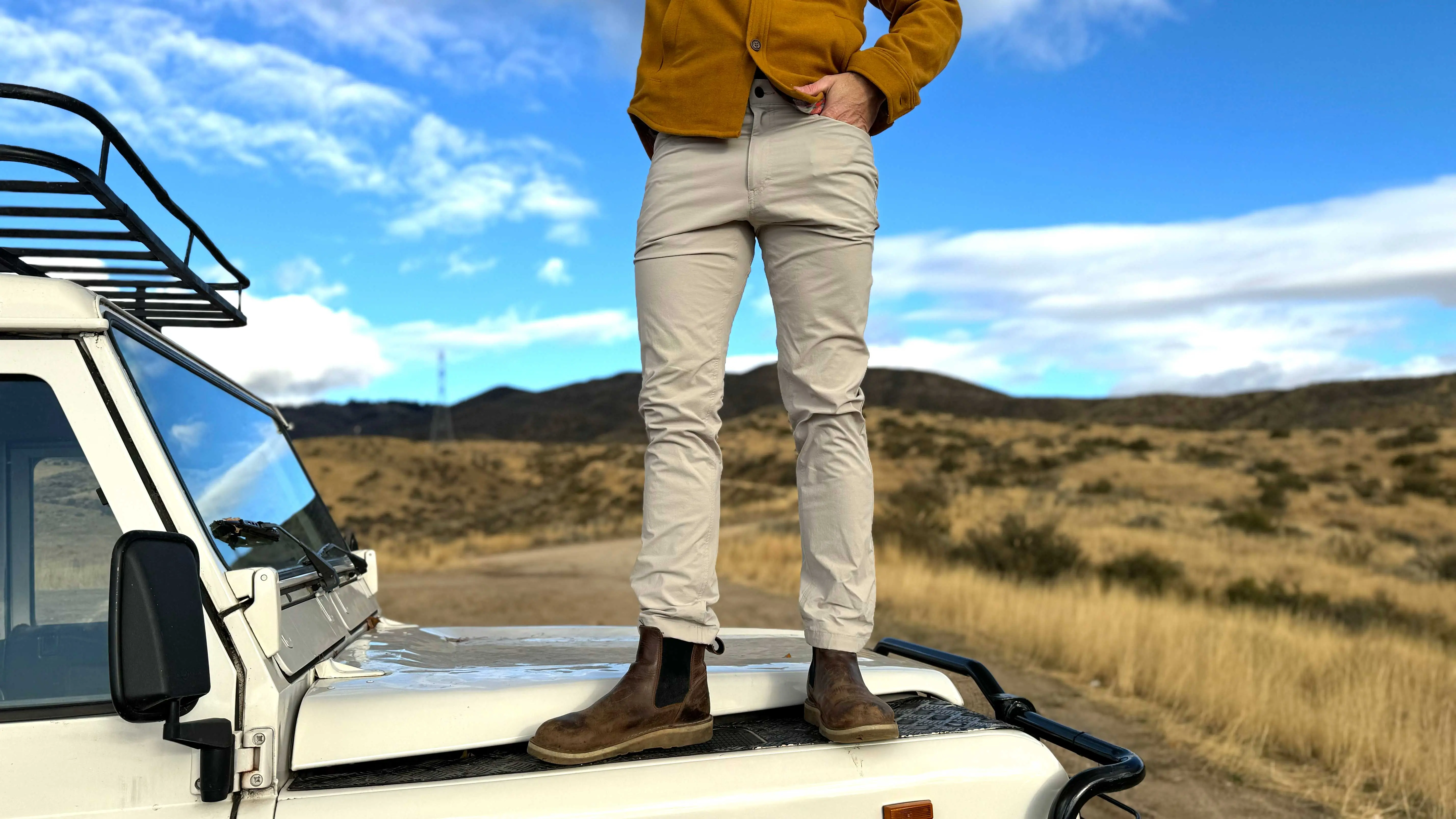 the author stands on the hood of his landrover wearing the western rise evolution 2 pants