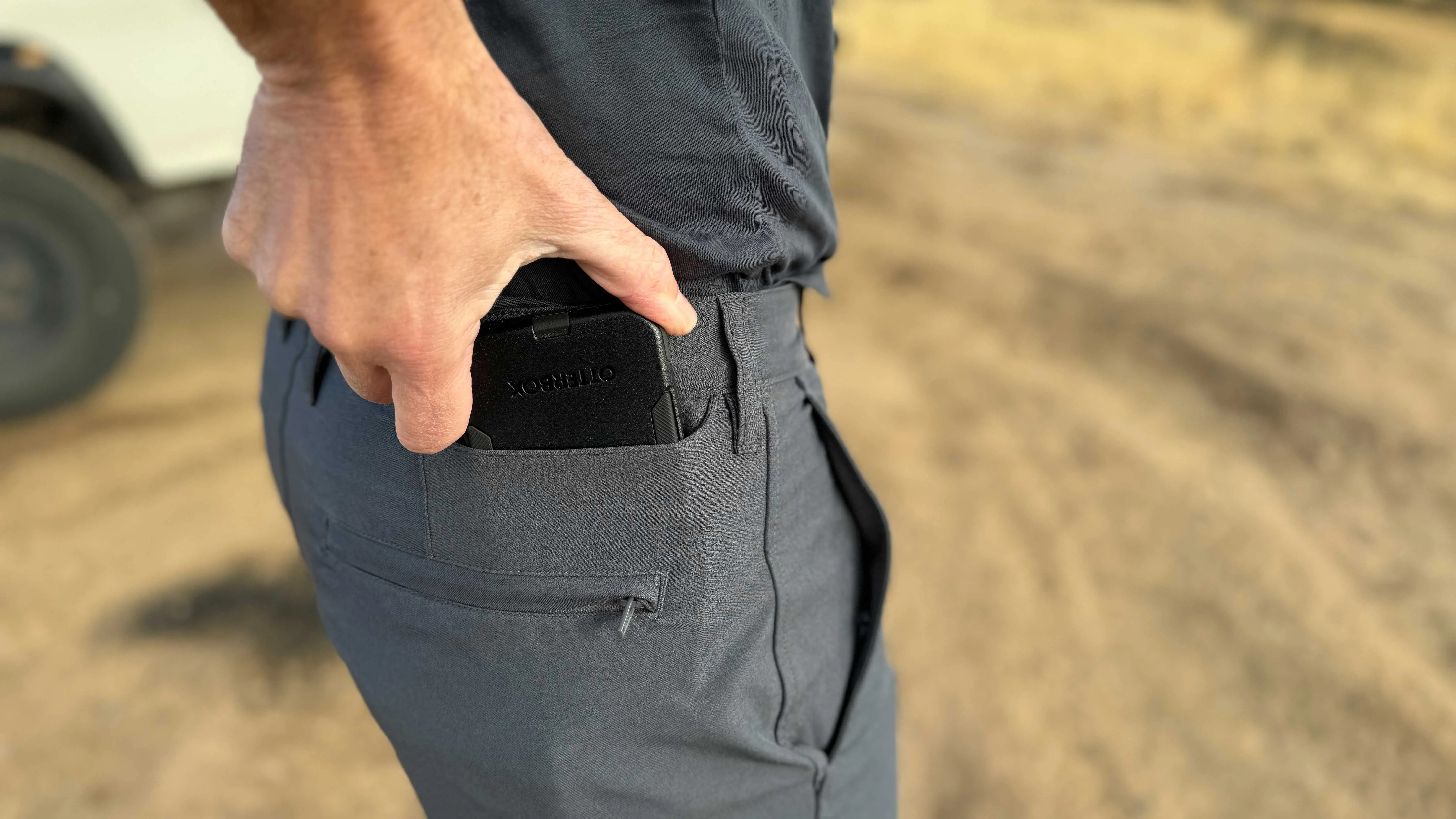 the author places his phone in the dedicated device pocket on the pants