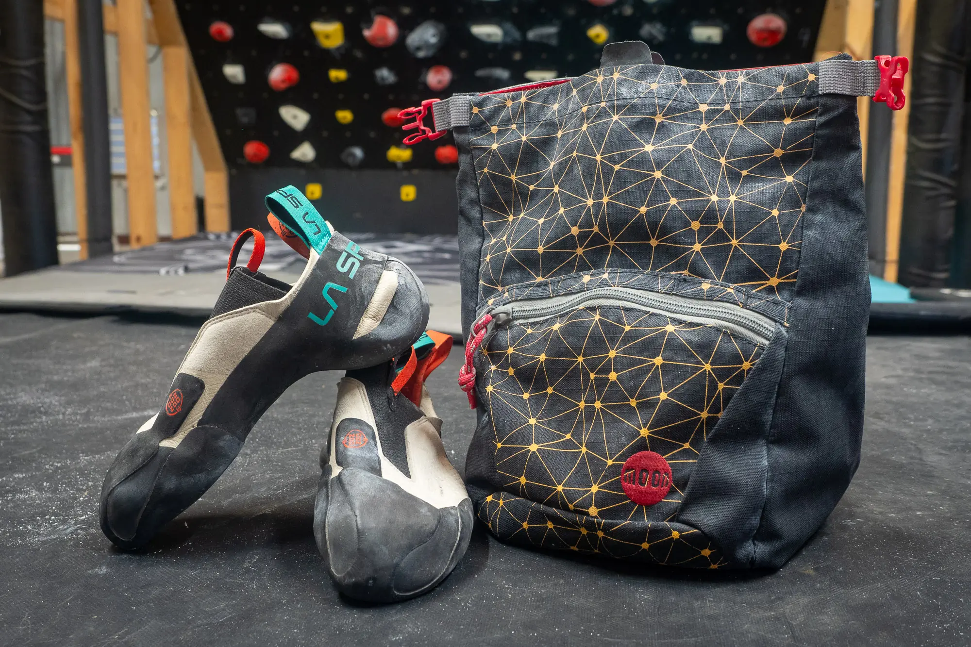 La Sportiva Mantra climbing shoe in front of a Moonboard