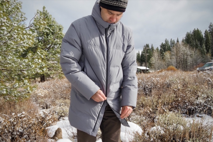 A man demonstrates the two-way front zipper of the Patagonia Jackson Glacier Parka.