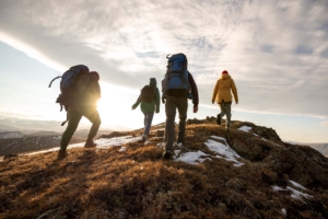 Group,Of,Four,Hikers,With,Backpacks,Walks,In,Mountains,At