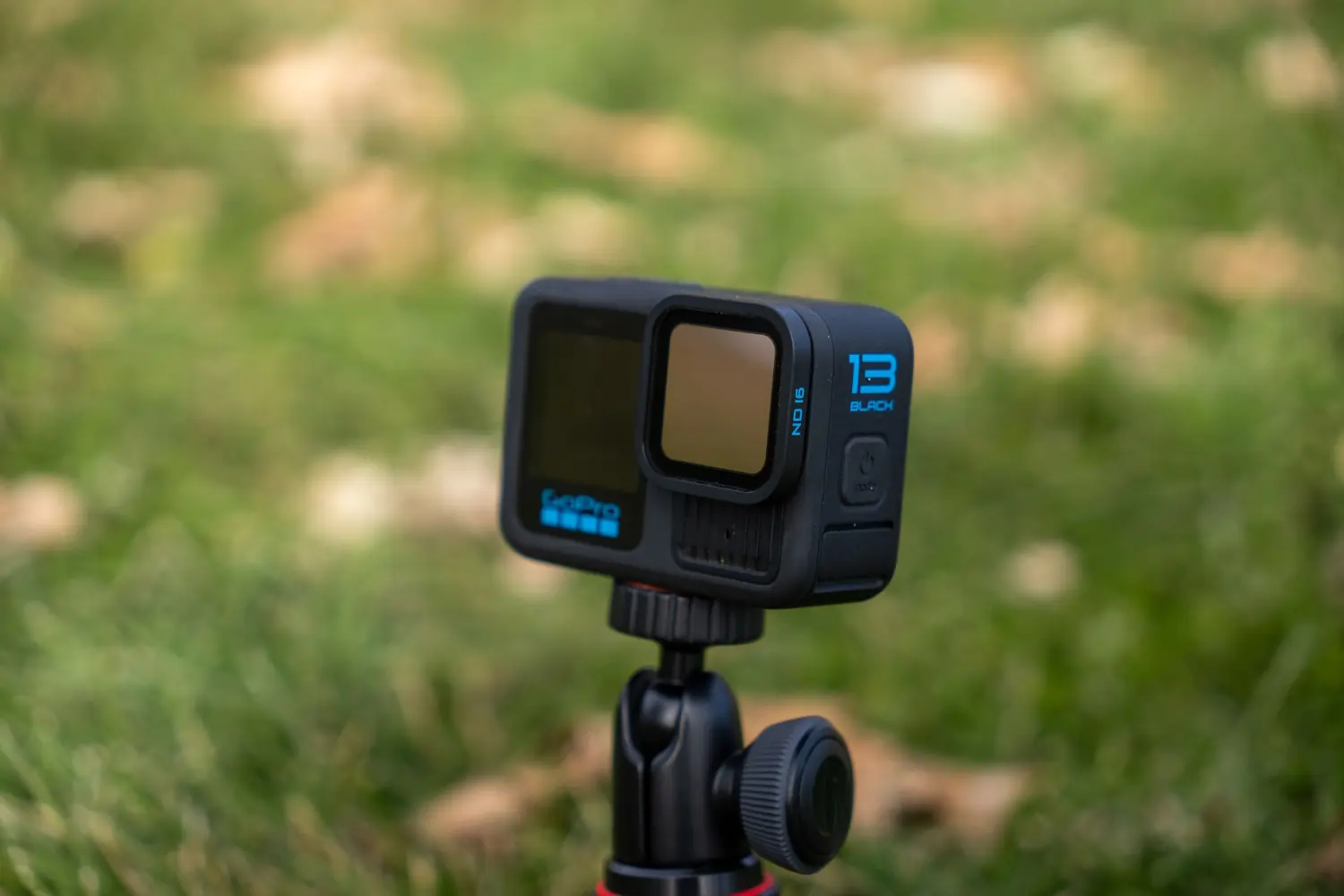 A GoPro HERO13 Black with an ND filter attached, mounted on a compact tripod