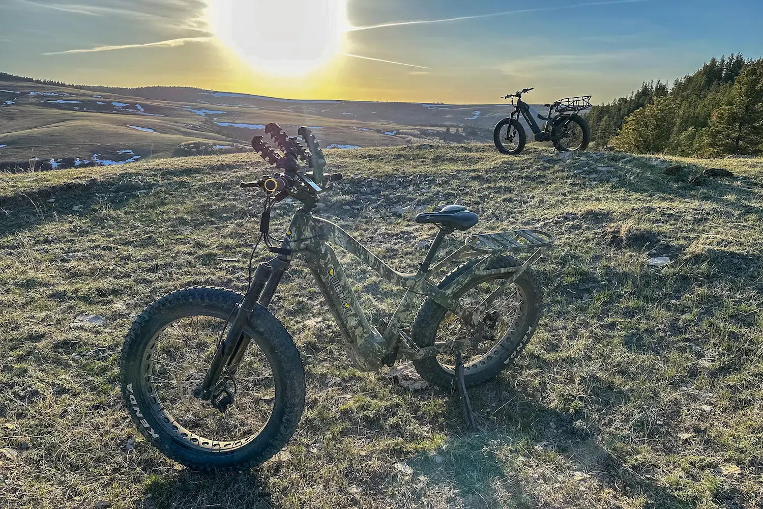 Two QuietKat e-bikes parked on a grassy knoll while scoping for bears