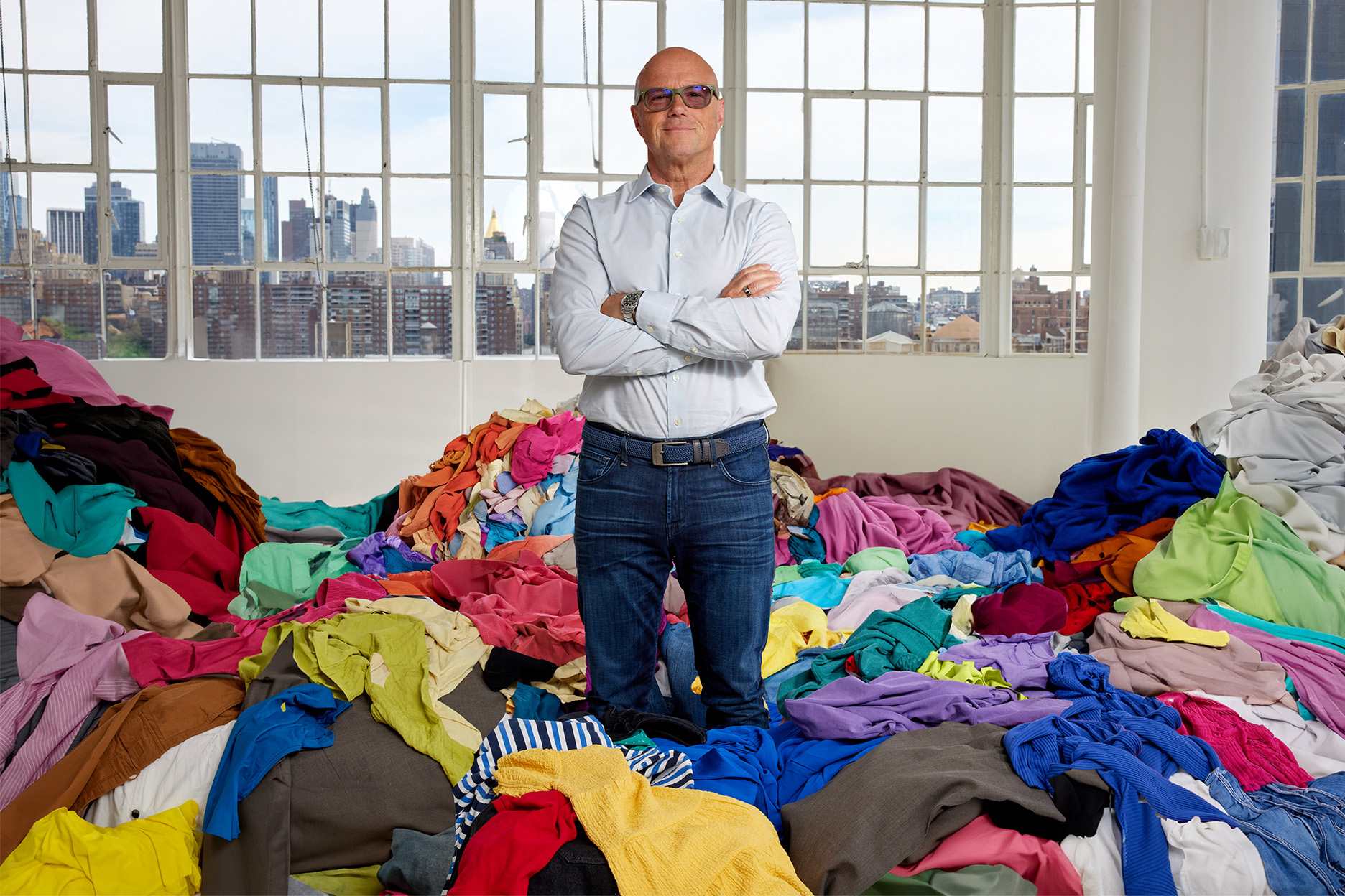Reju ceo ptrick frisk standing in a pile of clothes