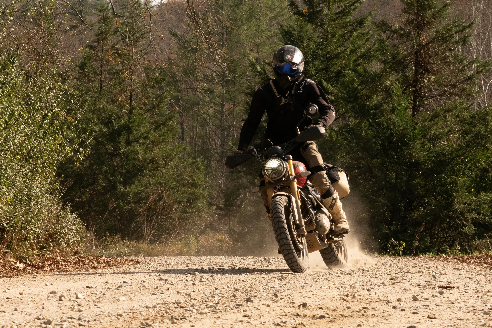 riding triumph scrambler 400 x on a gravel