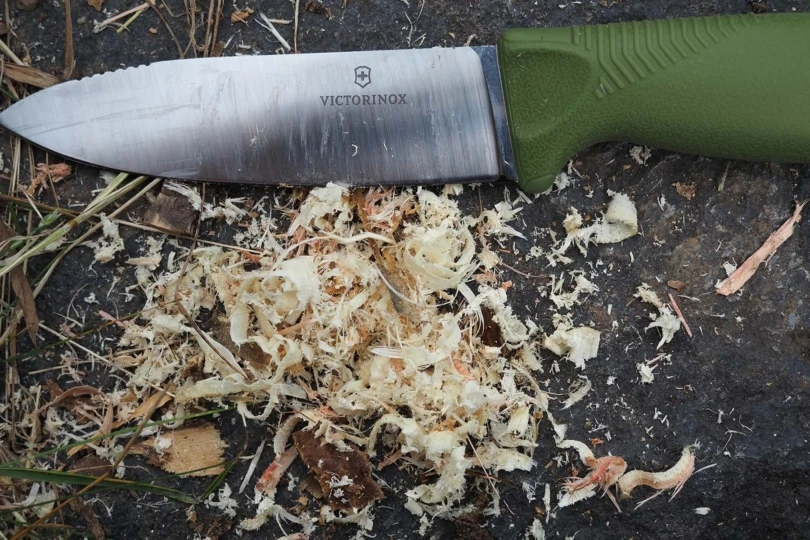 victorinox venture knife next to tinder shavings