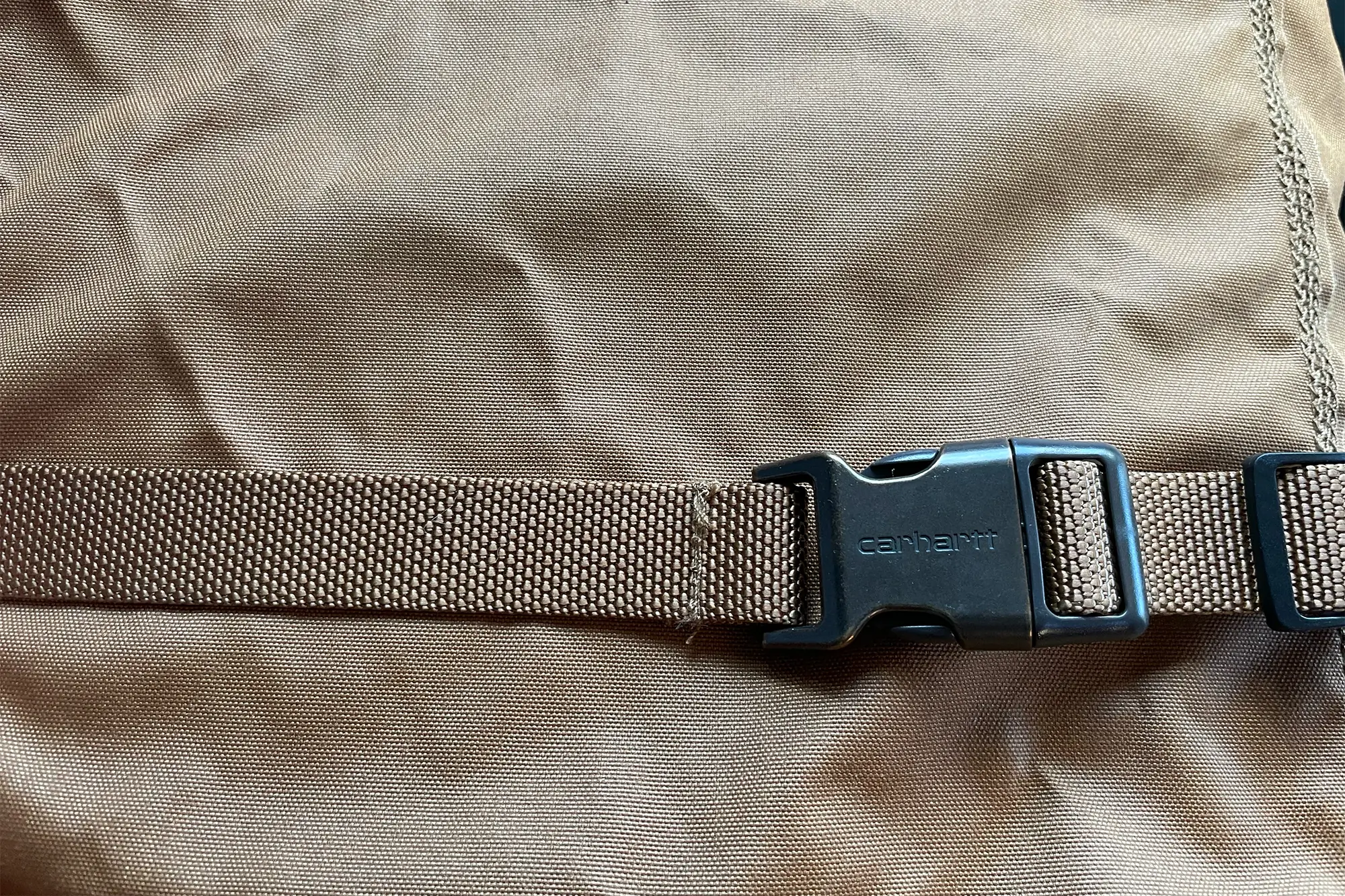 A strap buckles around the seat