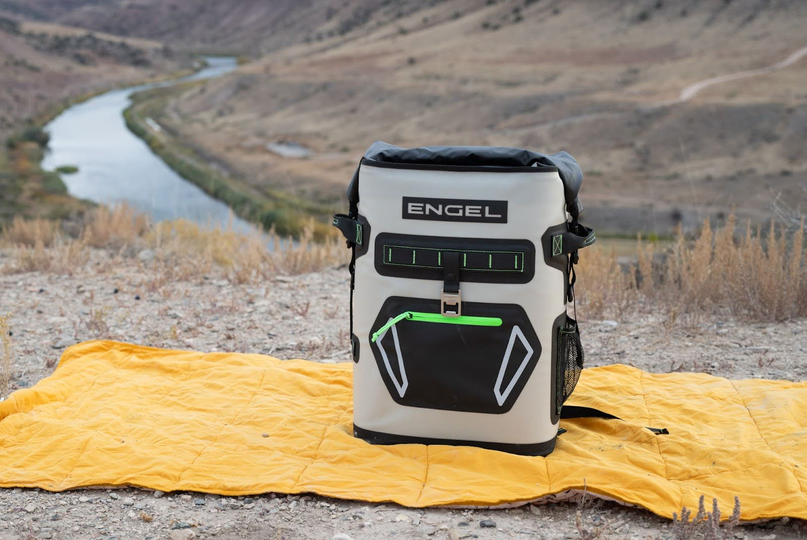Engel Roll Top High Performance Backpack Cooler with river in the background