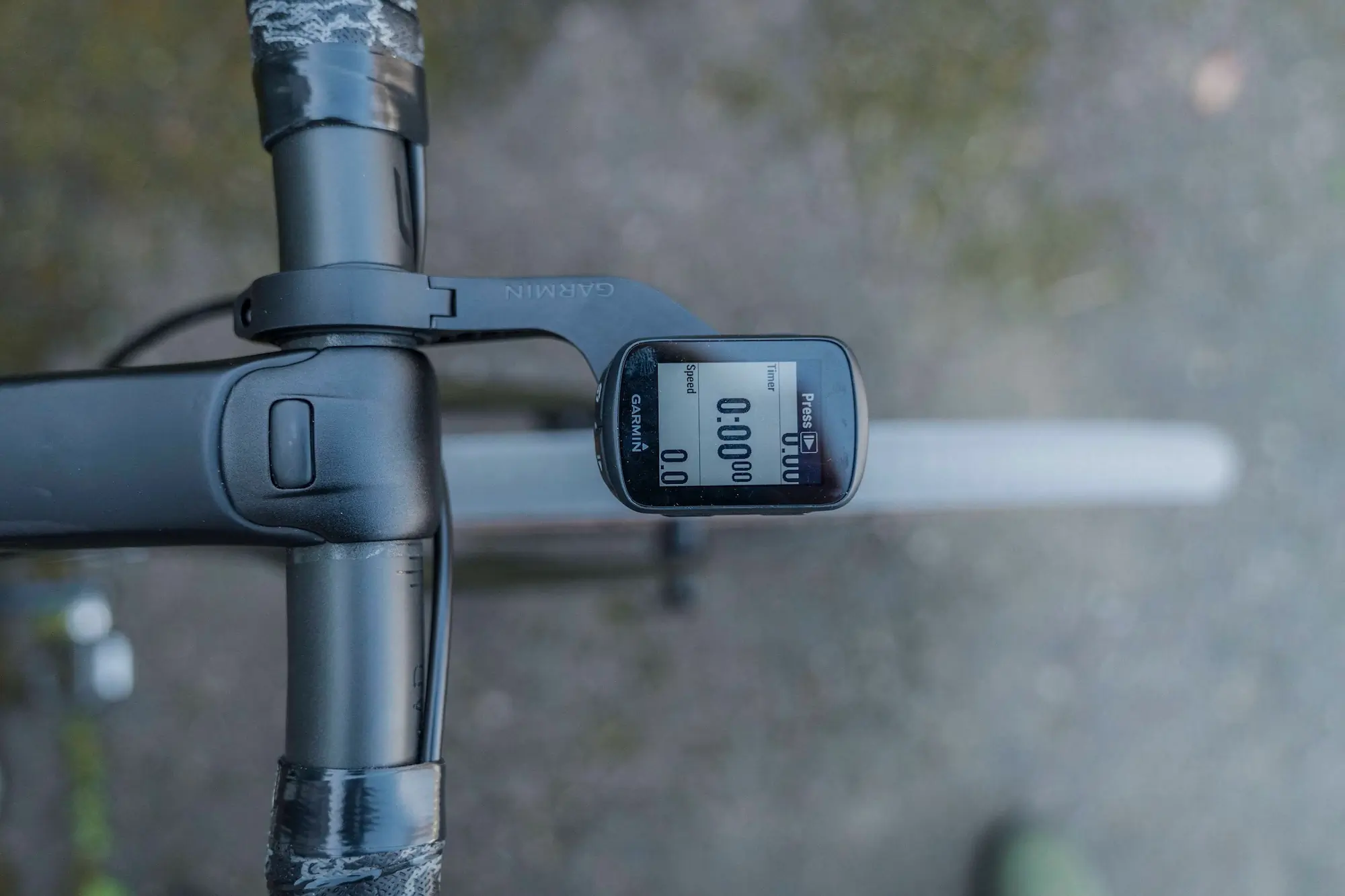 The Garmin Edge 130 Plus bike computer mounted to a road bike handlebar
