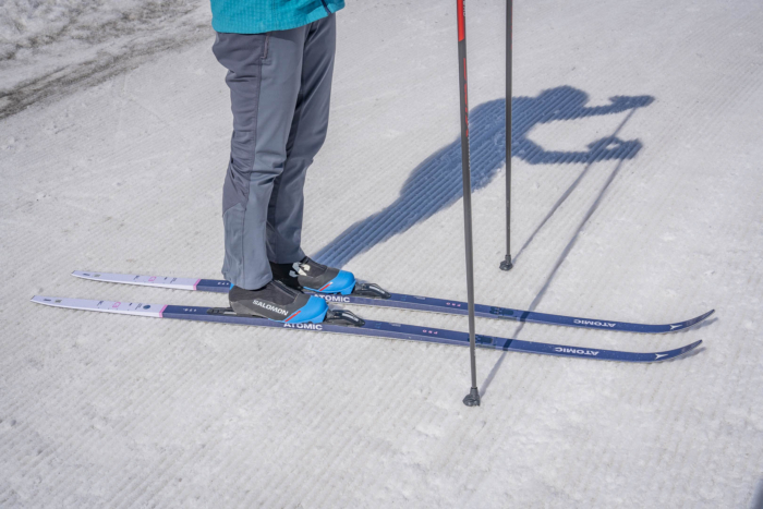 Skier standing with Atomic Pro C3 skis on groomed snow