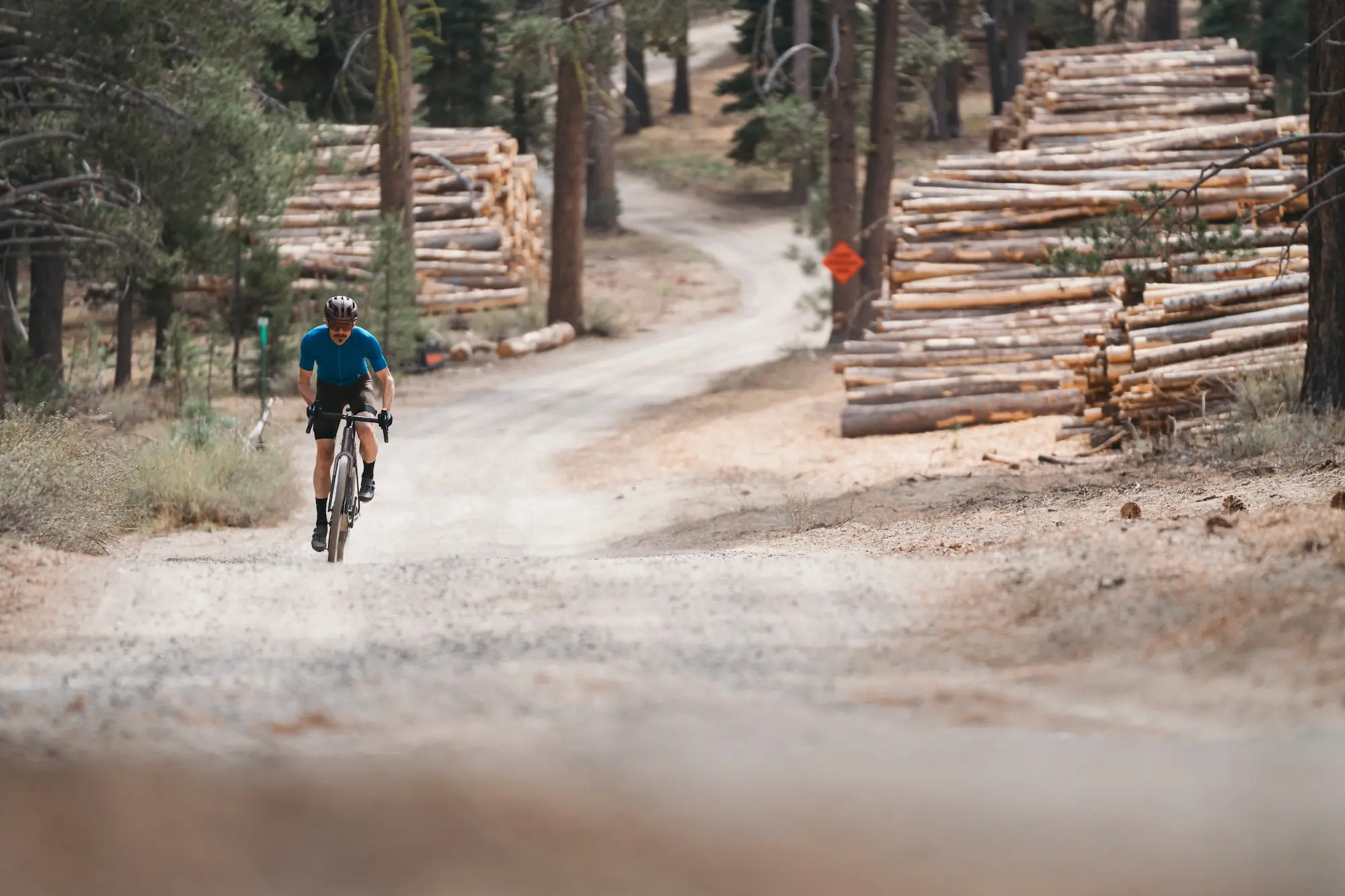 Climbing up a smooth gravel road aboard the Trek Checkpoint SL 7 AXS Gen 3 gravel bike