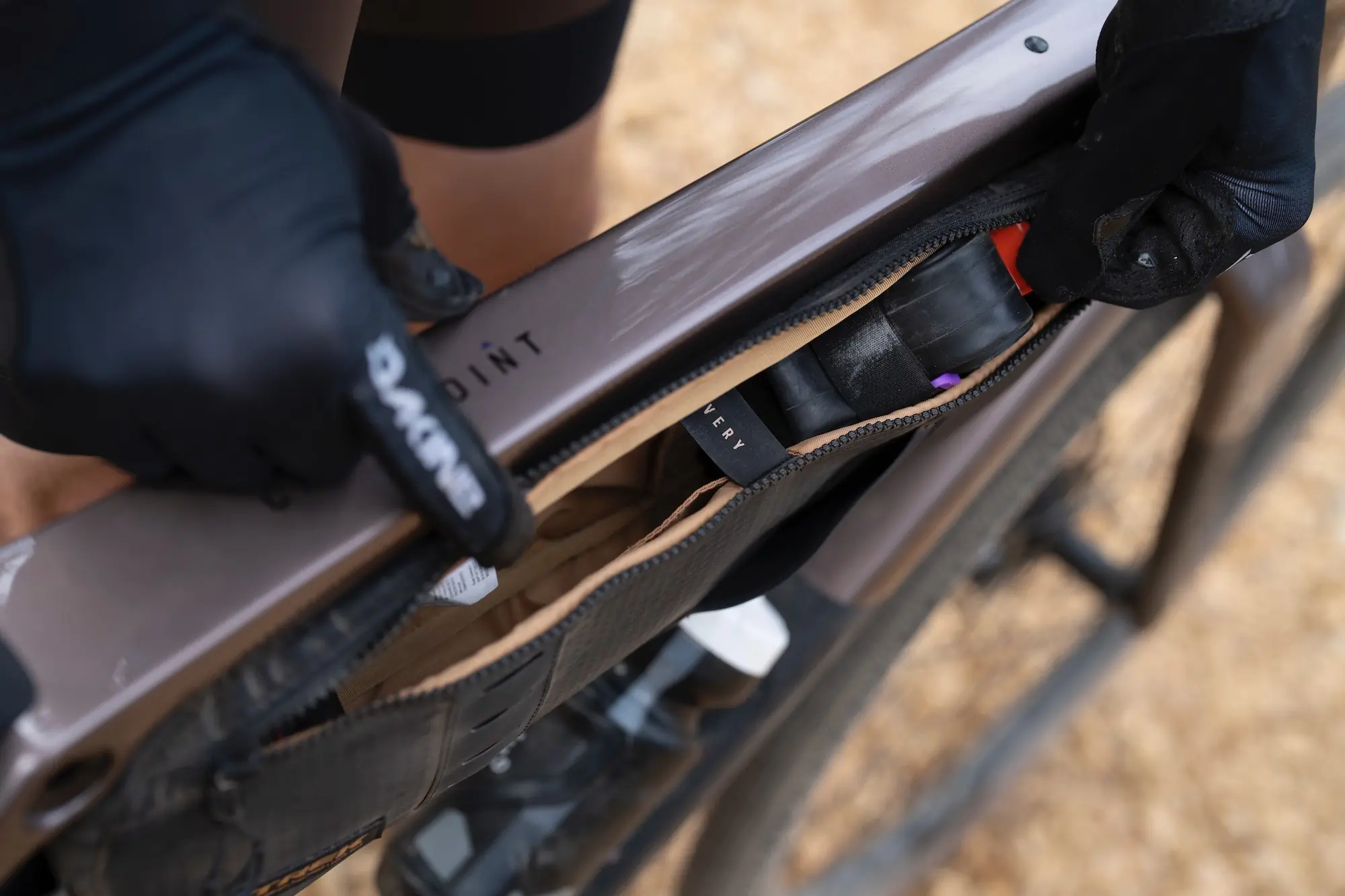 Pulling a tube and tire lever out of the Trek Adventure Frame Bag on the Checkpoint SL Gen 3