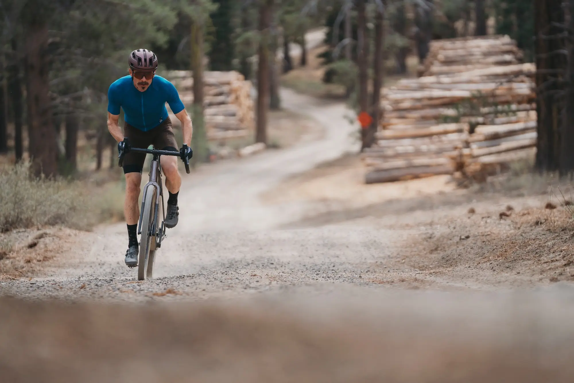 Climbing a gravel road in the forest on the Trek Checkpoint SL 7 AXS Gen 3 gravel bike