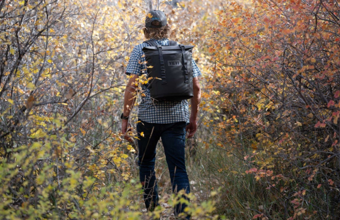 man wearing Yeti Hopper M12 Soft Backpack Cooler in the woods