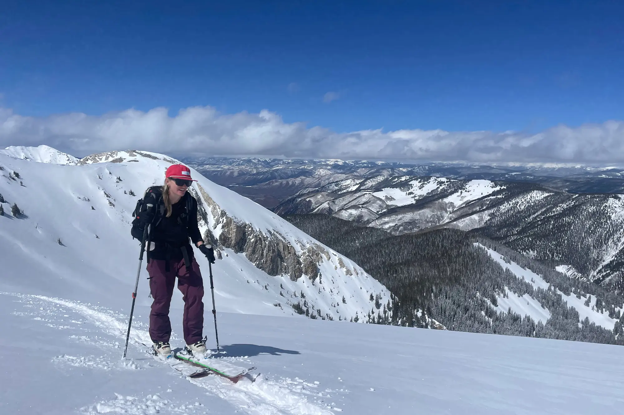 woman wearing black diamond recon lt pants while skiing