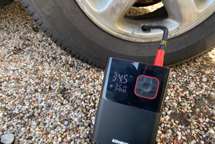 Using the Kohree Portable Tire Inflator to add air to the tire of a small SUV