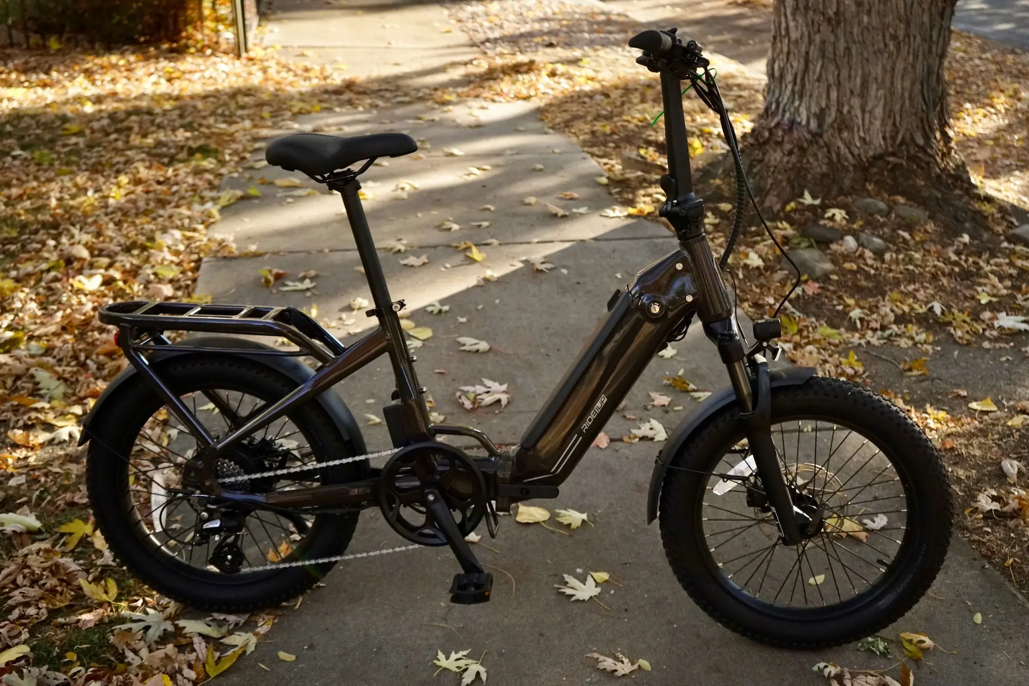 The Ride1Up Portola folding electric bike parked on a sidewalk