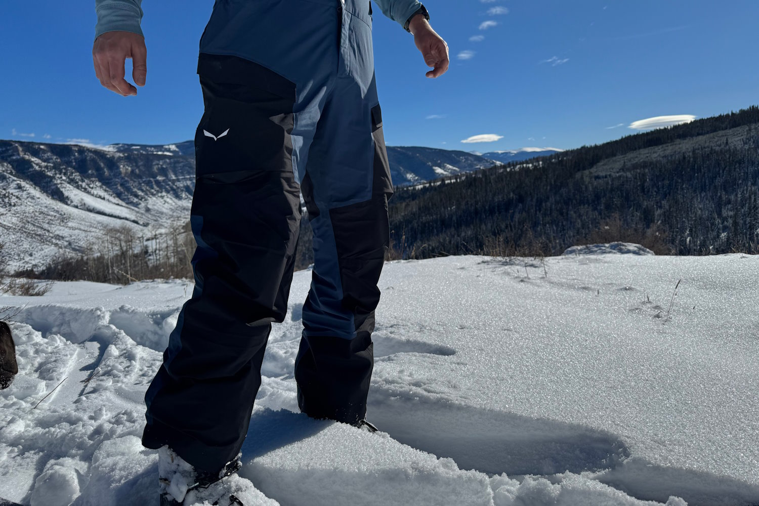 Person wearing Salewa Sella 3L pants standing in fresh snow