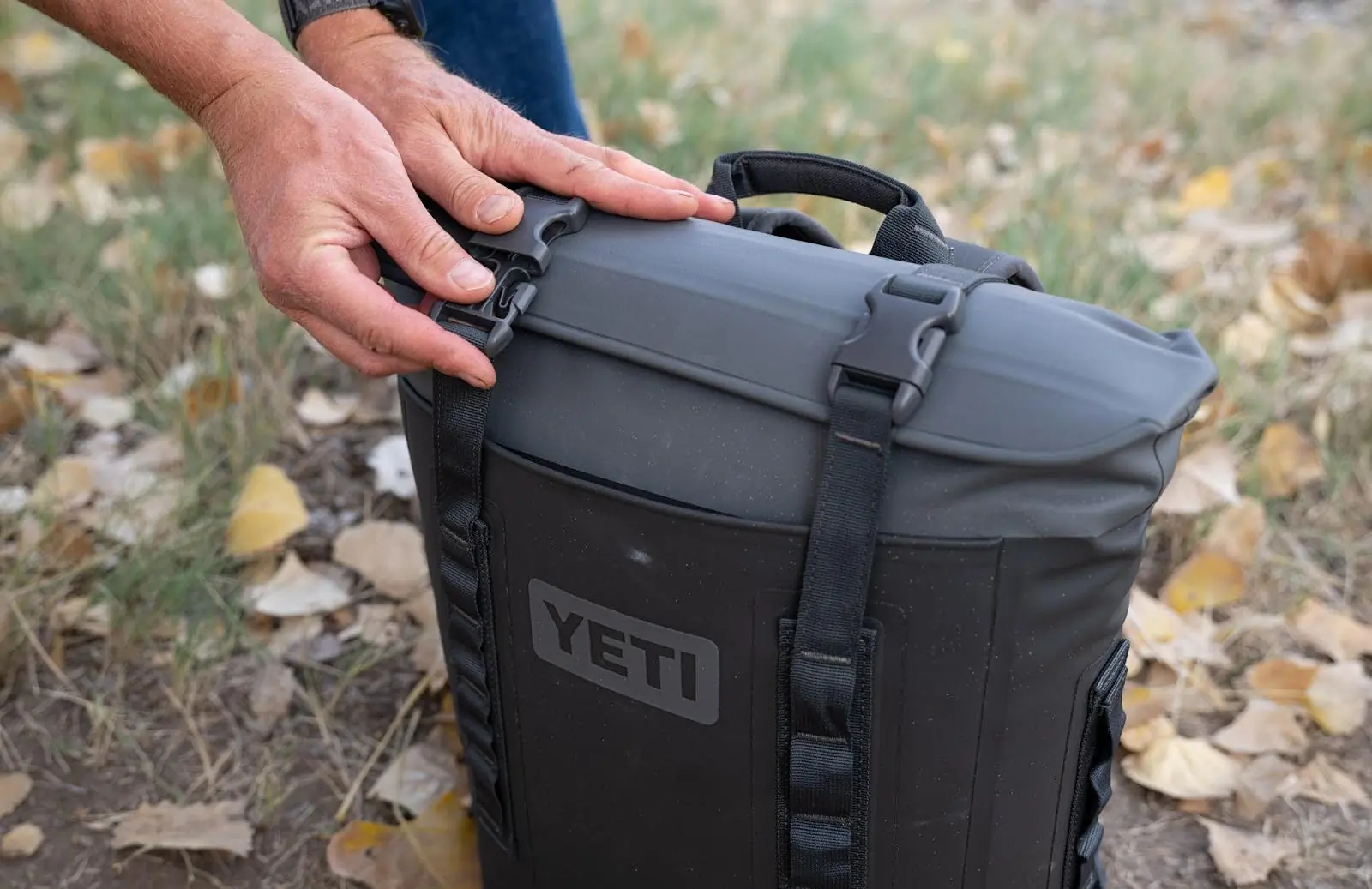 close up of man hands opening the Yeti Hopper M12 Soft Backpack Cooler
