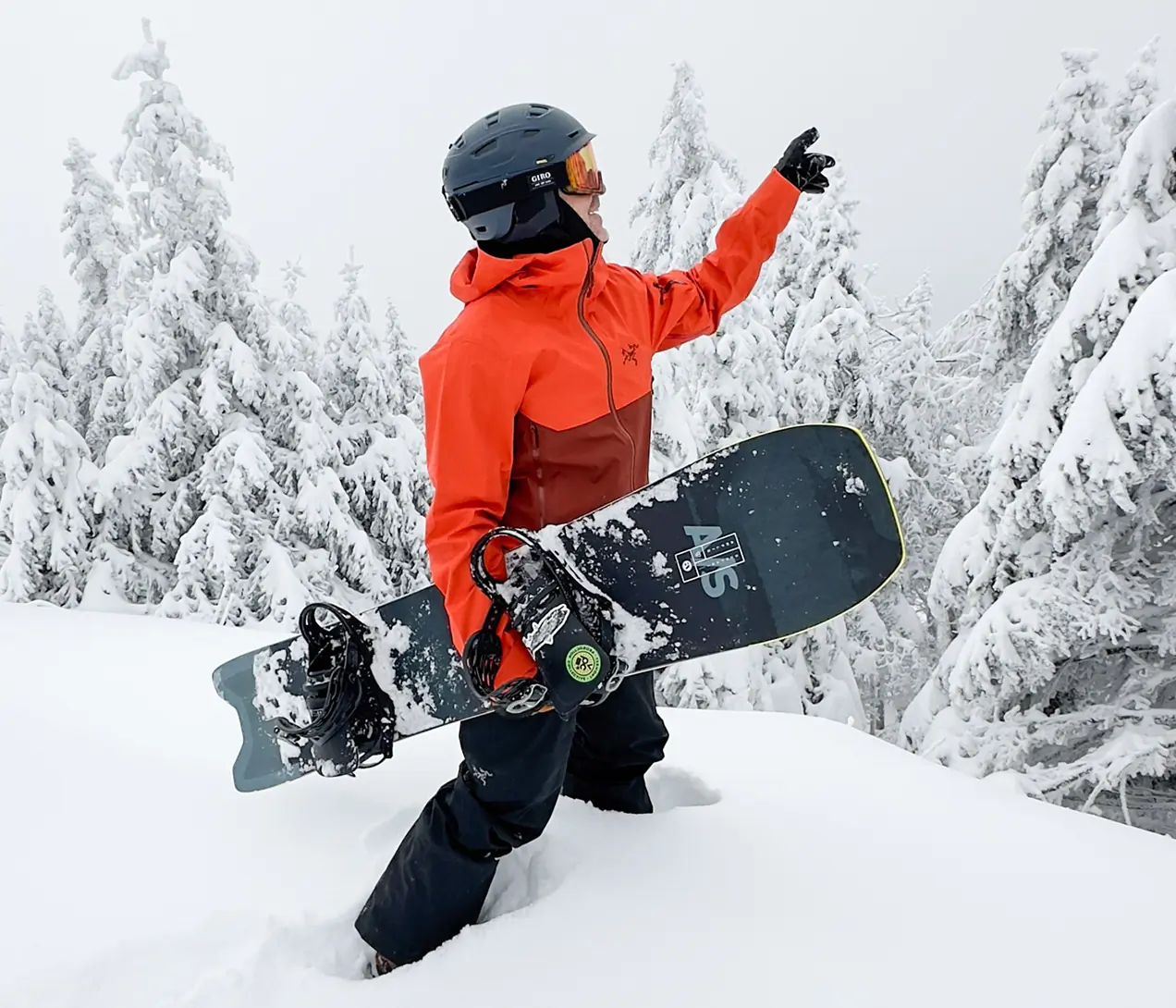 Snowboarder in deep snow pointing ahead, wearing the Arc'teryx Sabre 3L jacket