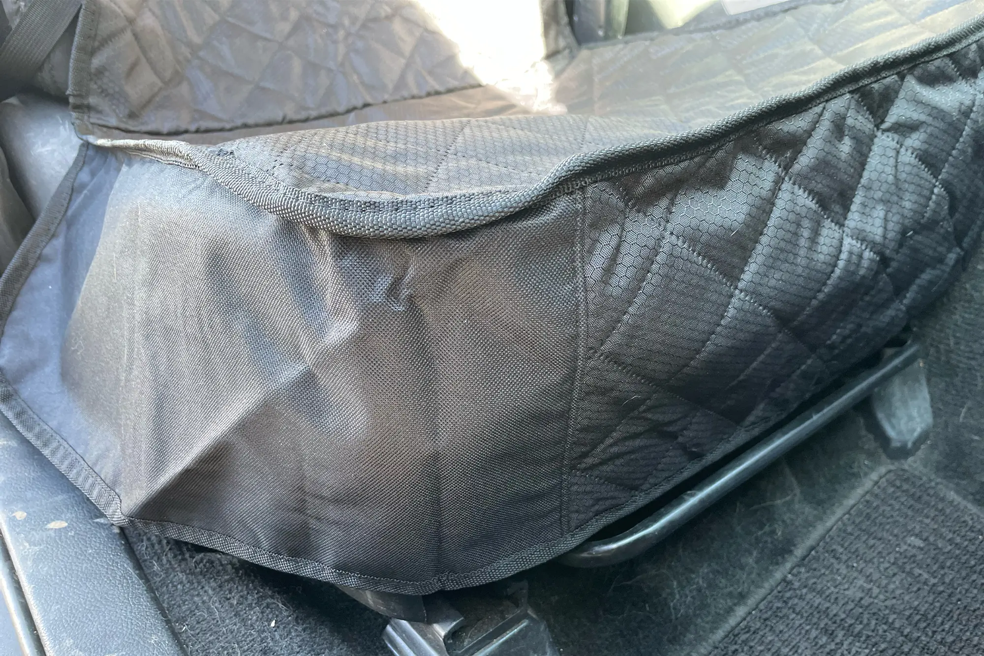 Skirt of the Paw Jamboree Car Seat Protector covering the lower seat area