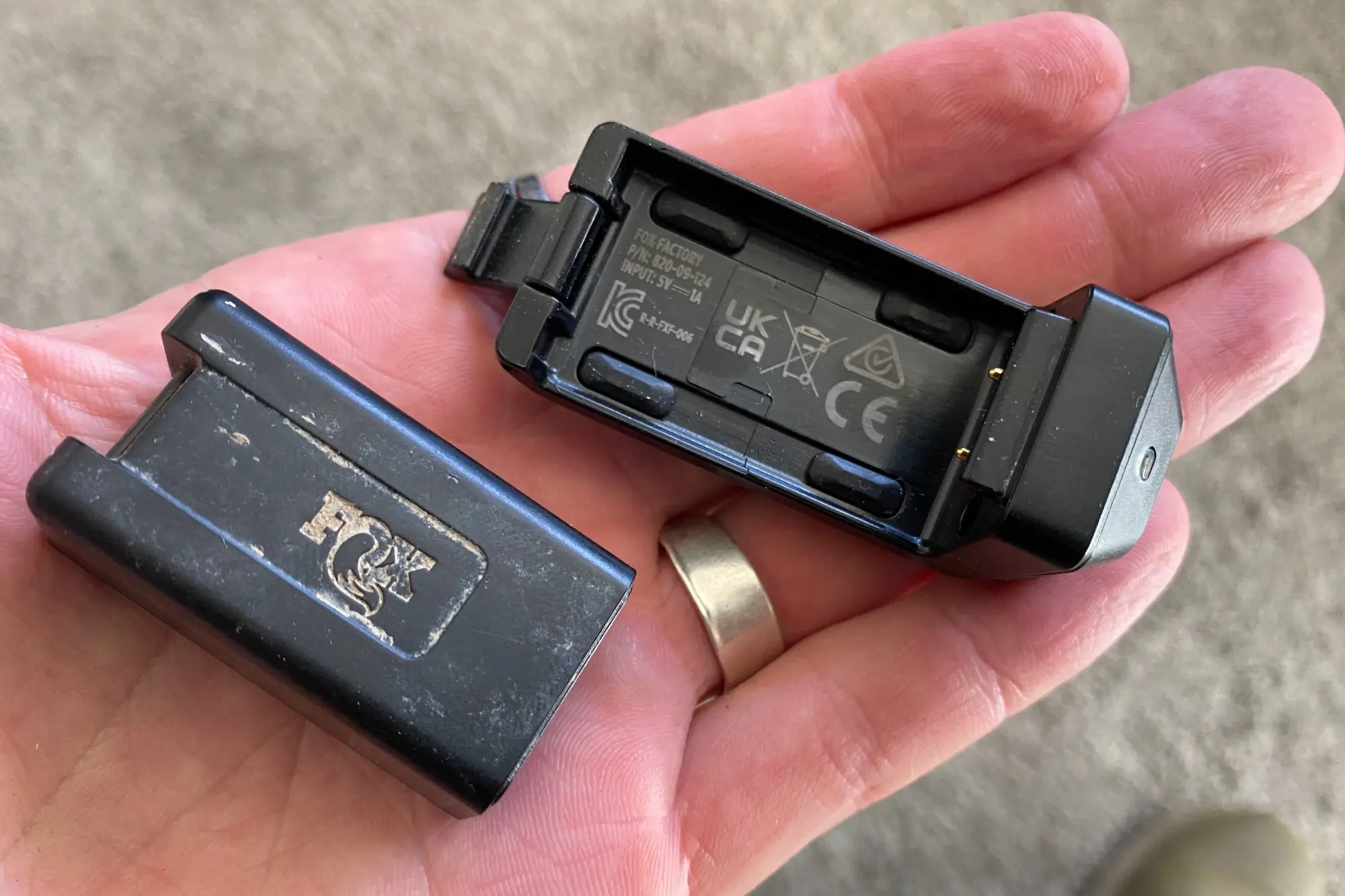 The battery and battery charger included with the Fox Transfer Neo dropper post