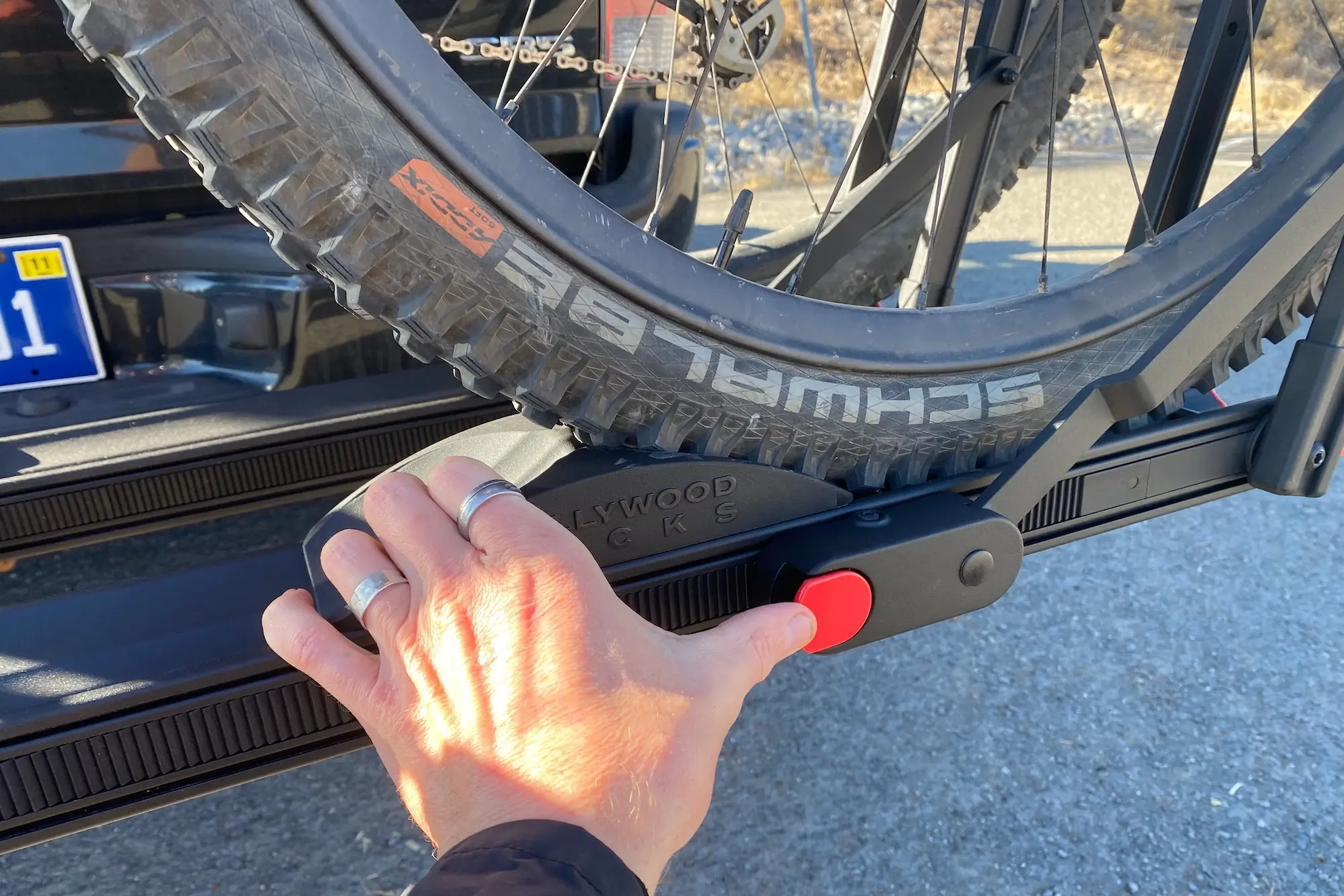 Pressing the wheel arm release button on the Hollywood Racks CrossTrack