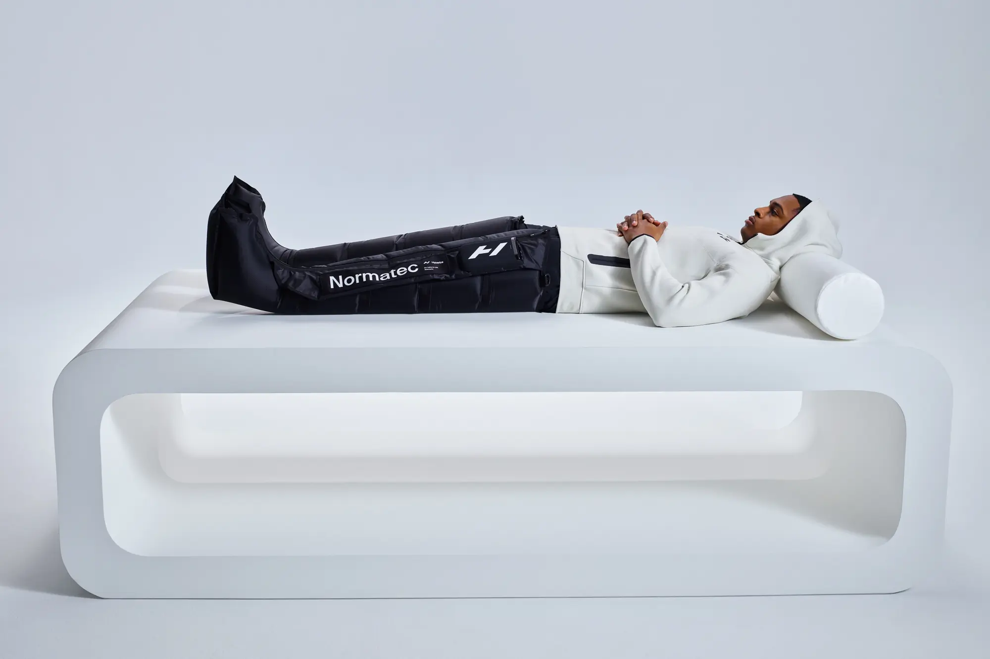Hyperice Normatec Elite compression boots on man
