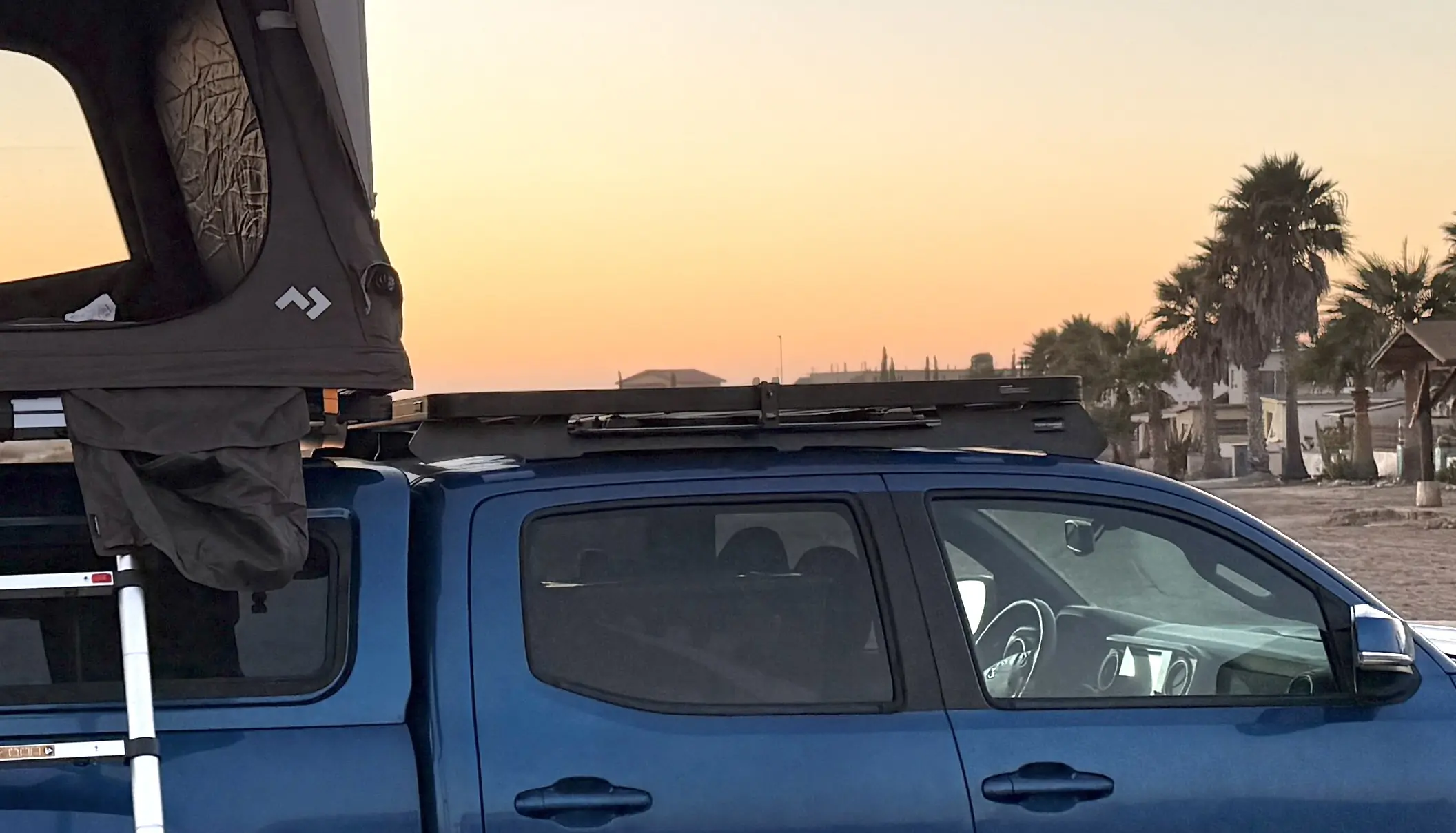 The Dometic aluminum camp table slides into the under rack table bracket that's installed inside the Slimline II tray on the truck cab