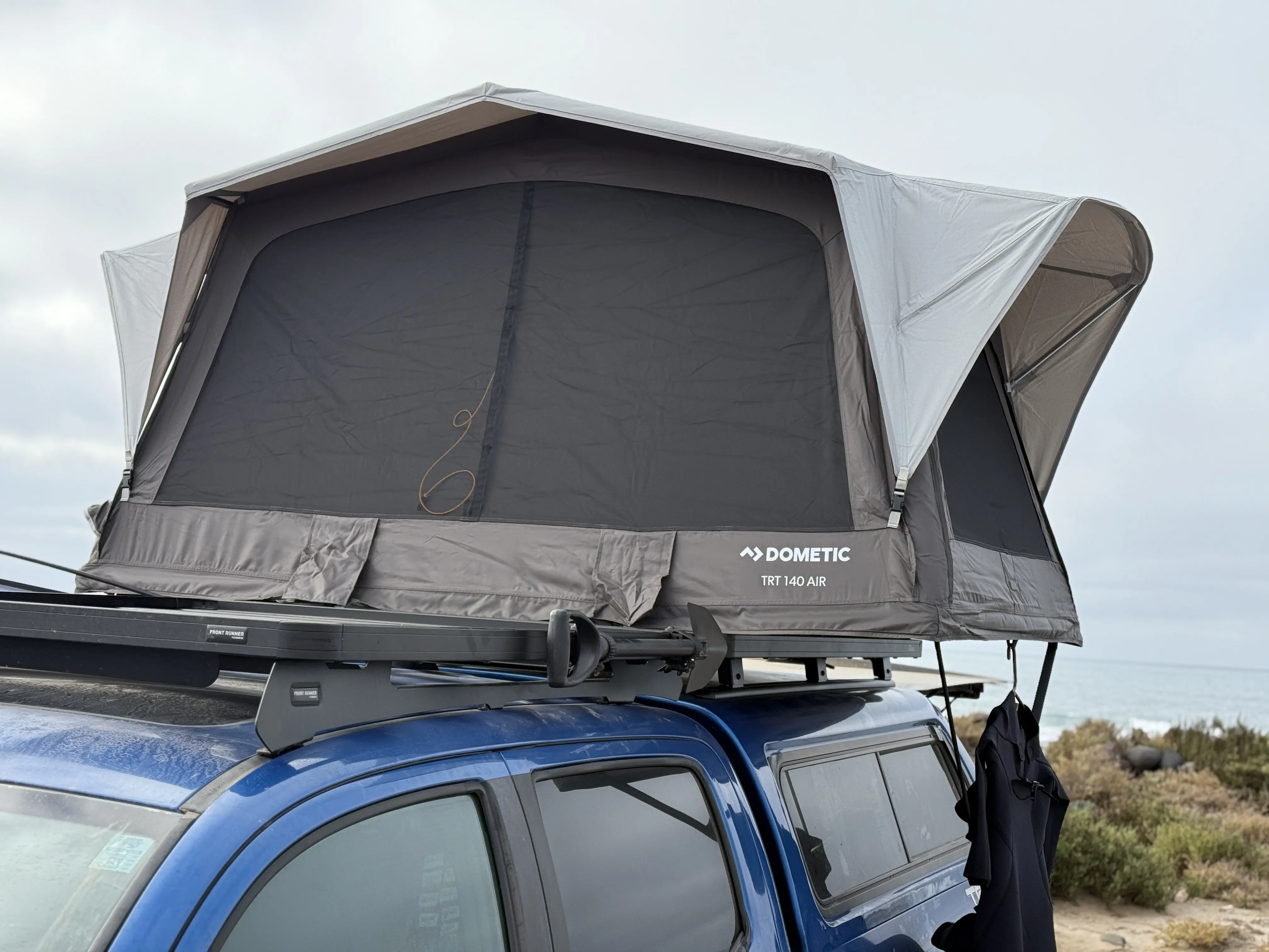 Dometic off-road shovel kit mounted to the Slimline II tray while the Dometic TRT 140 Air is open on the rack