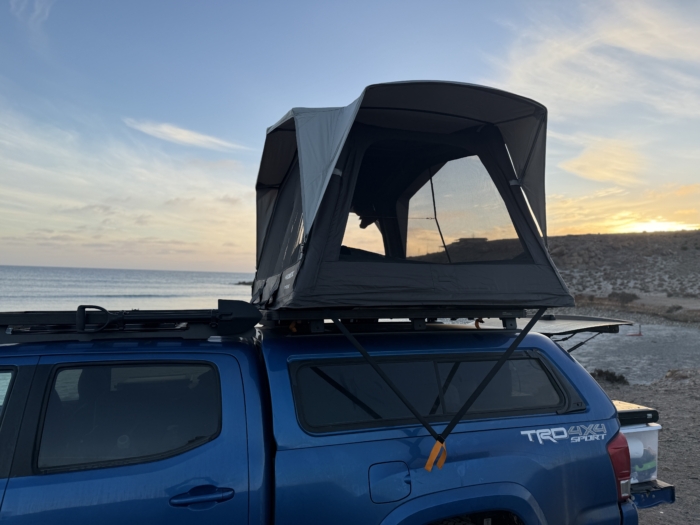 Open mesh walls and sunset view of the Dometic TRT 140 Air Inflatable Rooftop Tent 