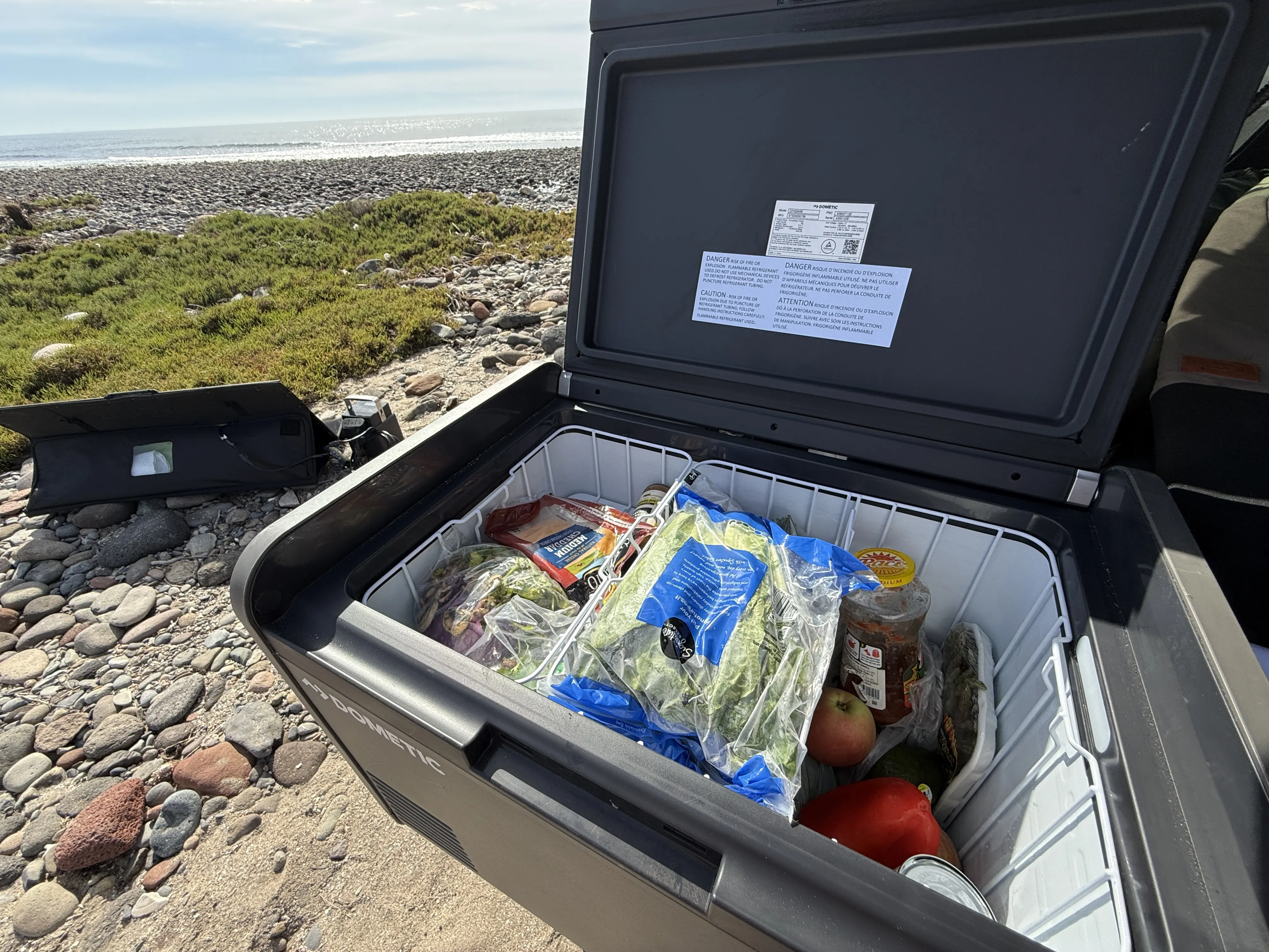 Open lid showing fresh food stocked inside the CFX 55IM Electric Cooler 