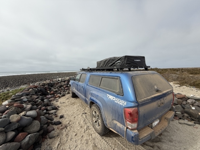 The Dometic TRT 140 Air Inflatable Rooftop Tent on a truck topper with the tent cover on