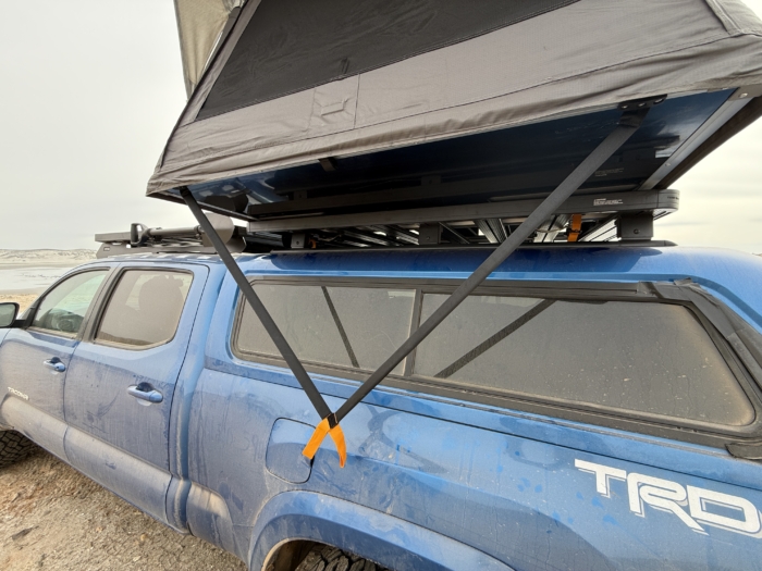 The two rigid, lean arms that help fold up or open the sections of the Dometic TRT 140 Air Inflatable Rooftop Tent