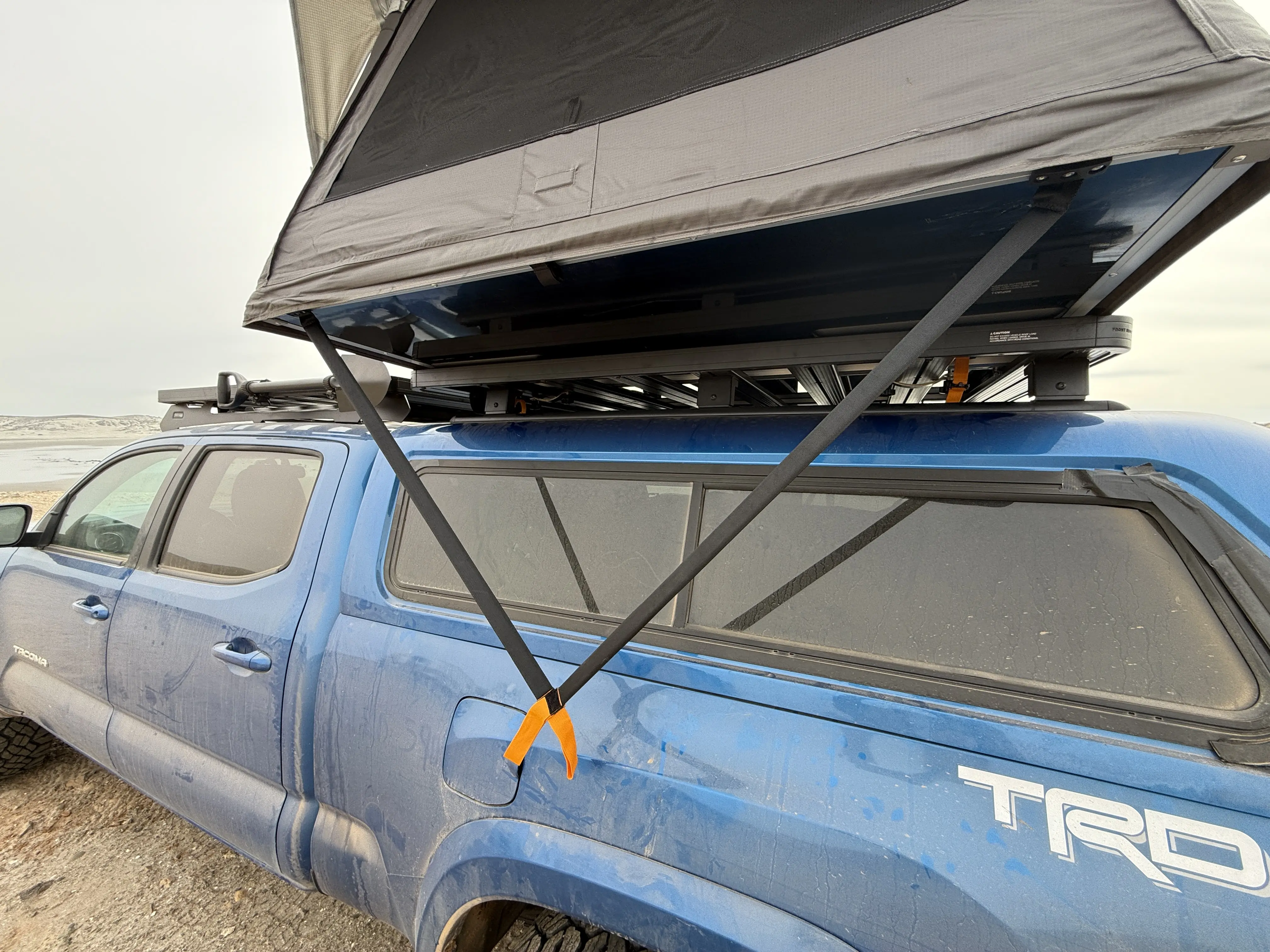 The two rigid, lean arms that help fold up or open the sections of the Dometic TRT 140 Air Inflatable Rooftop Tent